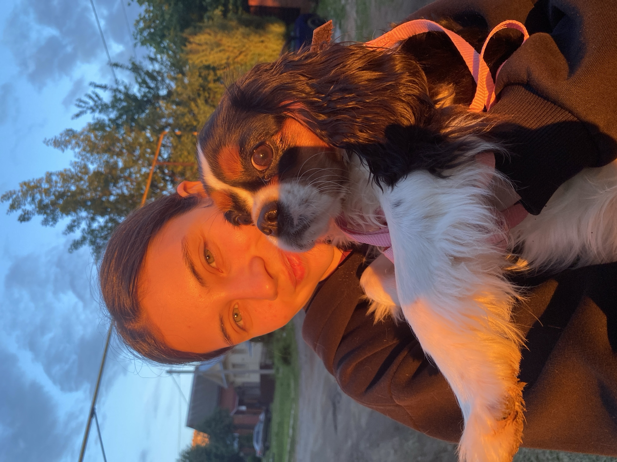 Woman poses with dog during sunset in Votkinsk, Russia