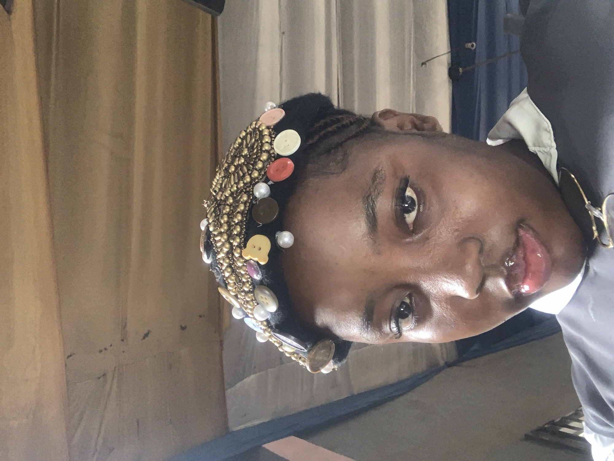Traditional ceremonial dress photographed alongside religious materials in Aba