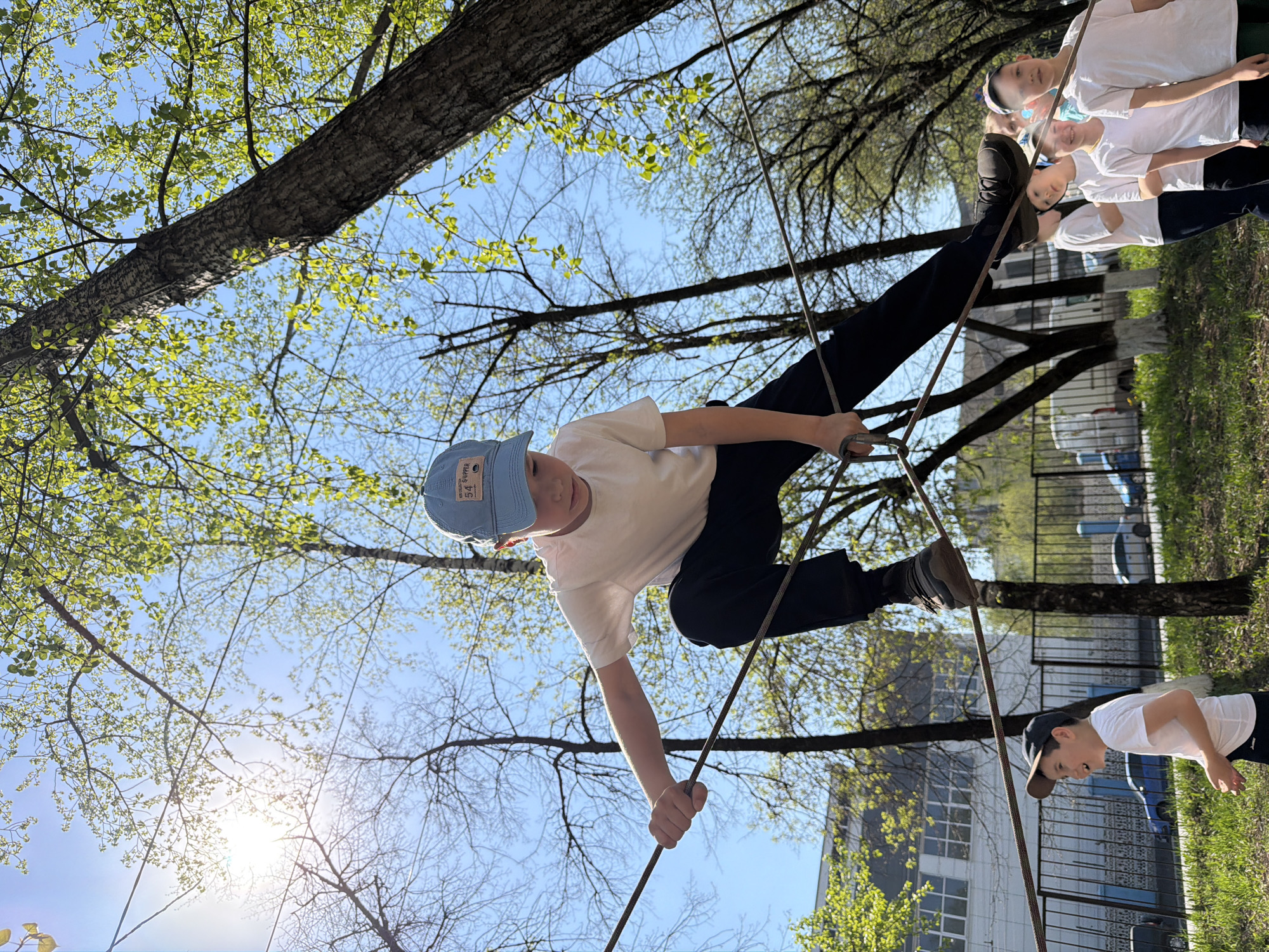 Children participate in rope course activities at Izhevsk park