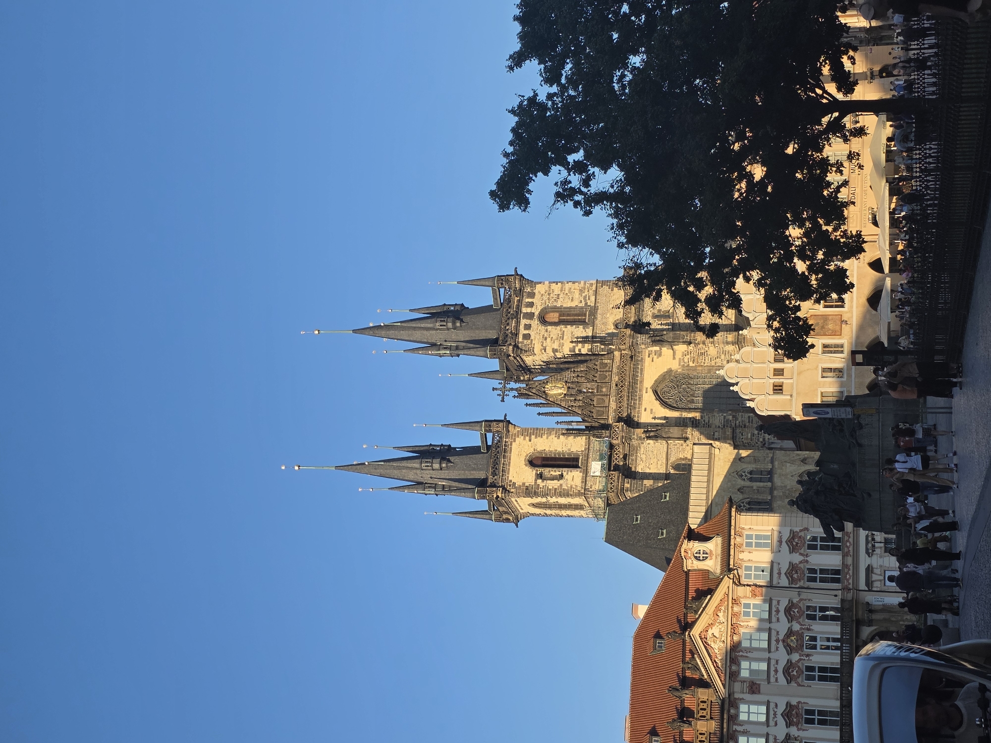 Tourist captures Prague Old Town scenes during golden hour