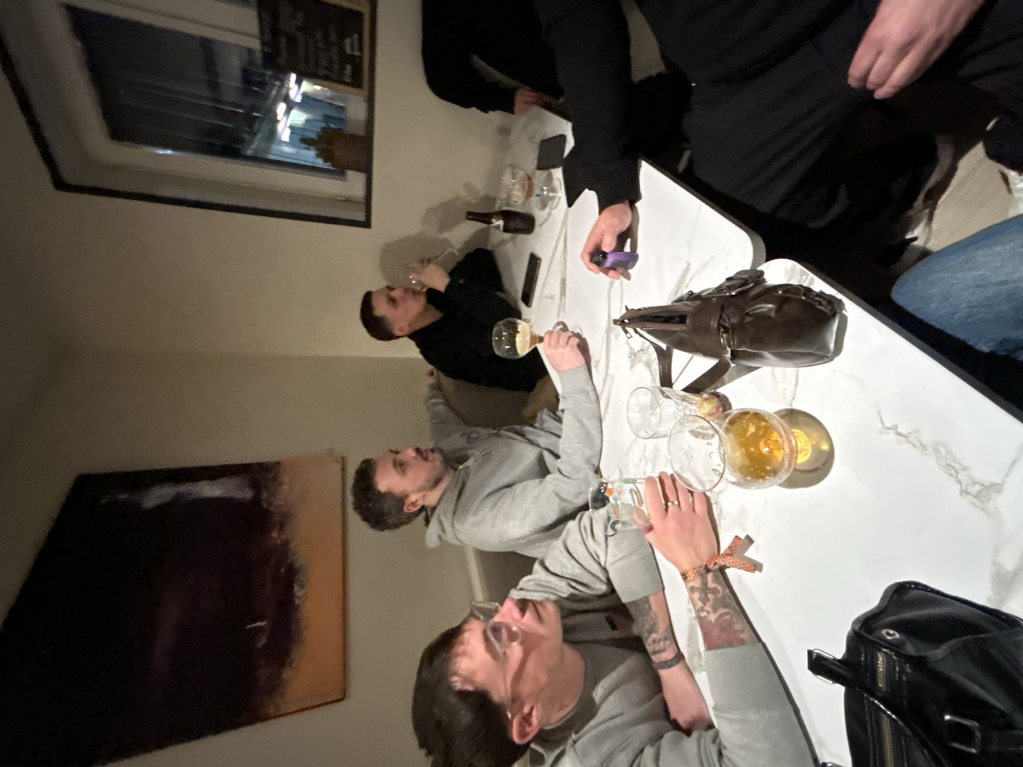 Group shares drinks at table in Hem, France