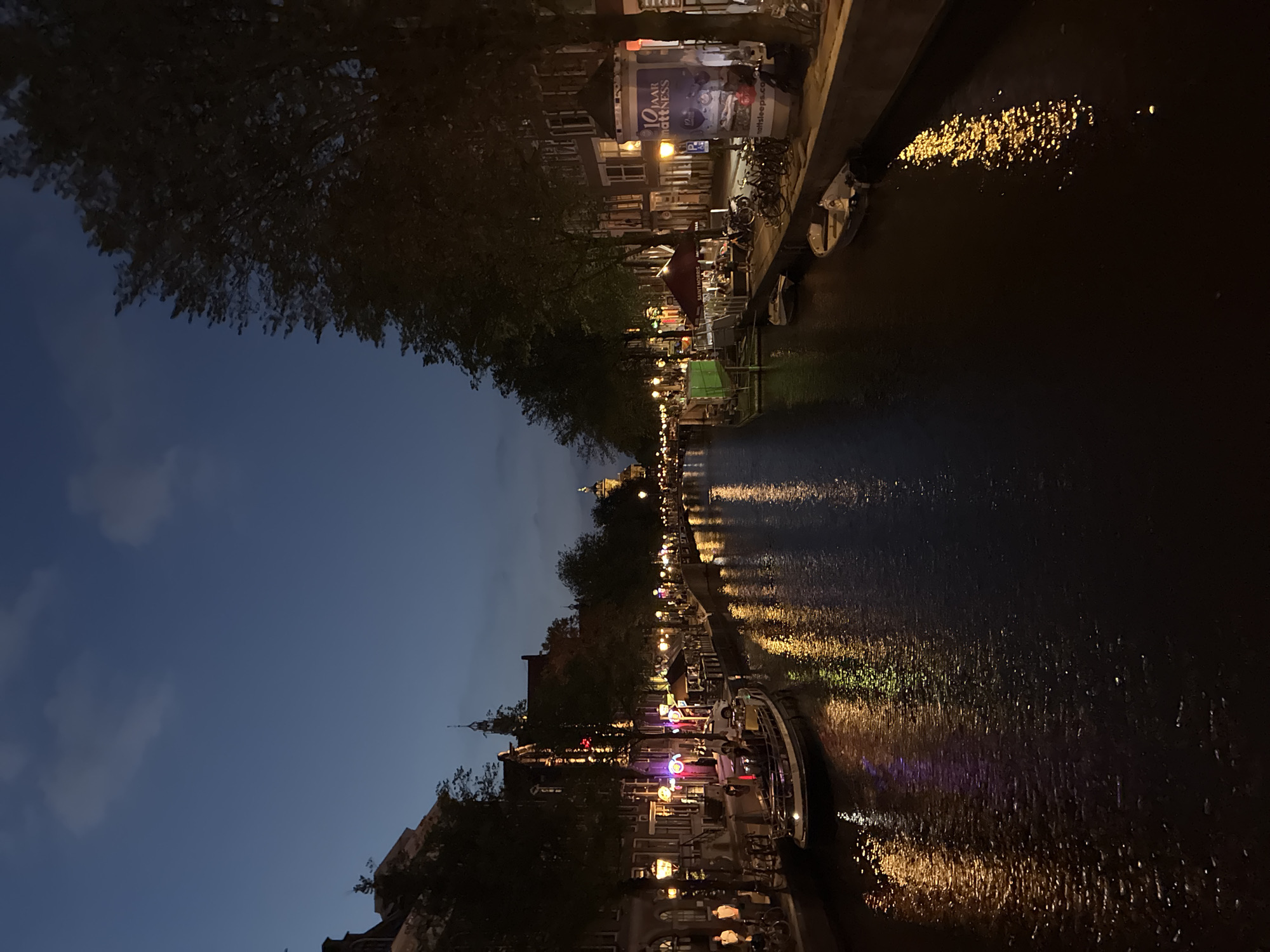 Amsterdam canals and storefronts at dusk, midsummer evening