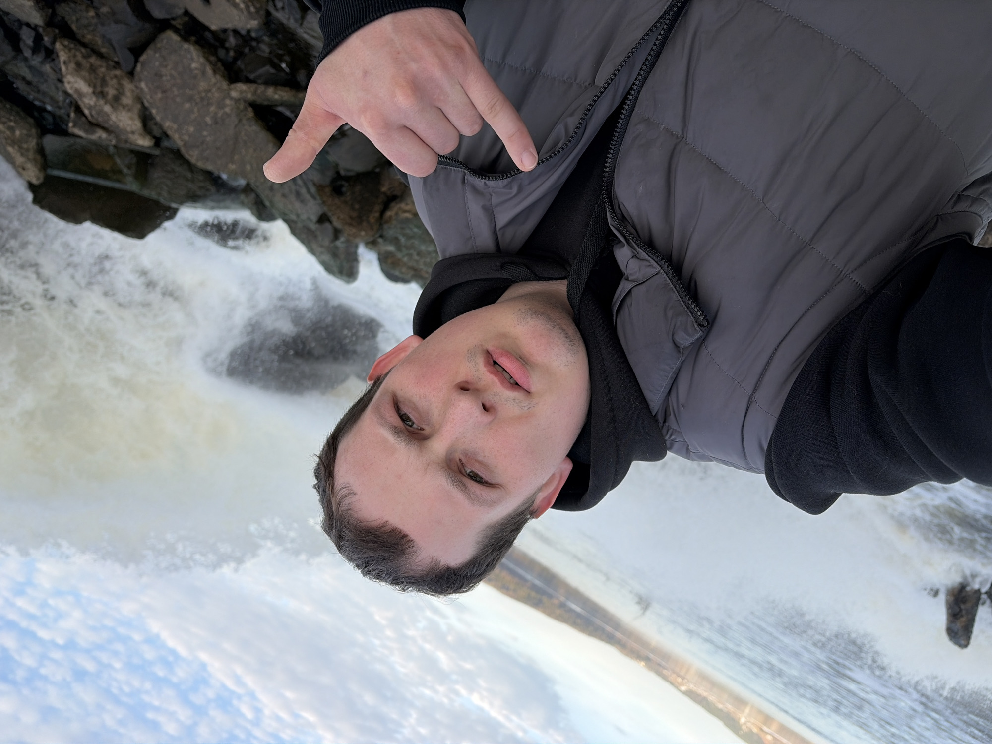 Visitors document waterfall dam site in Chernushka, Russia