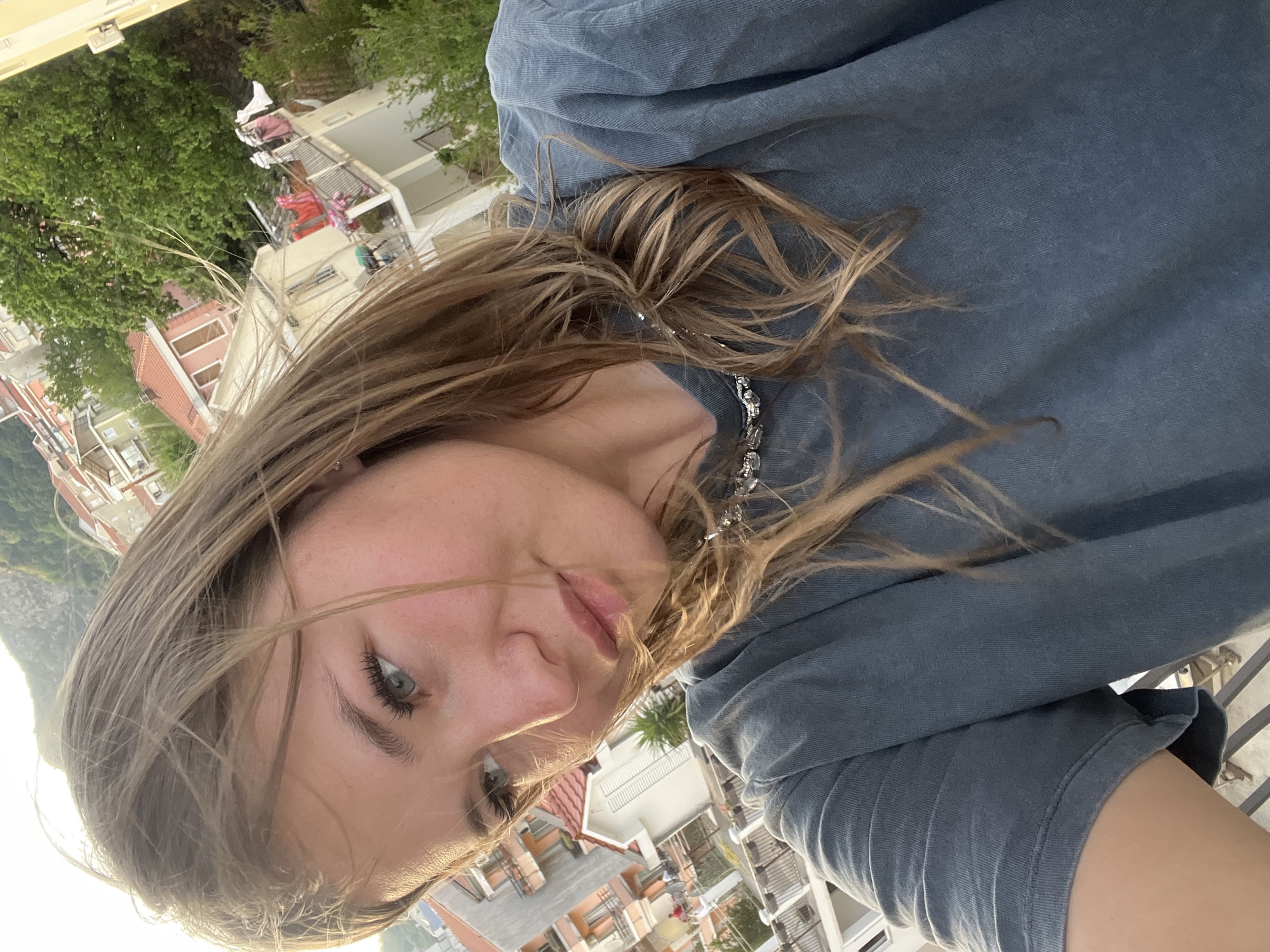 Tourist Takes Selfies Against Mountain Backdrop in Budva Montenegro