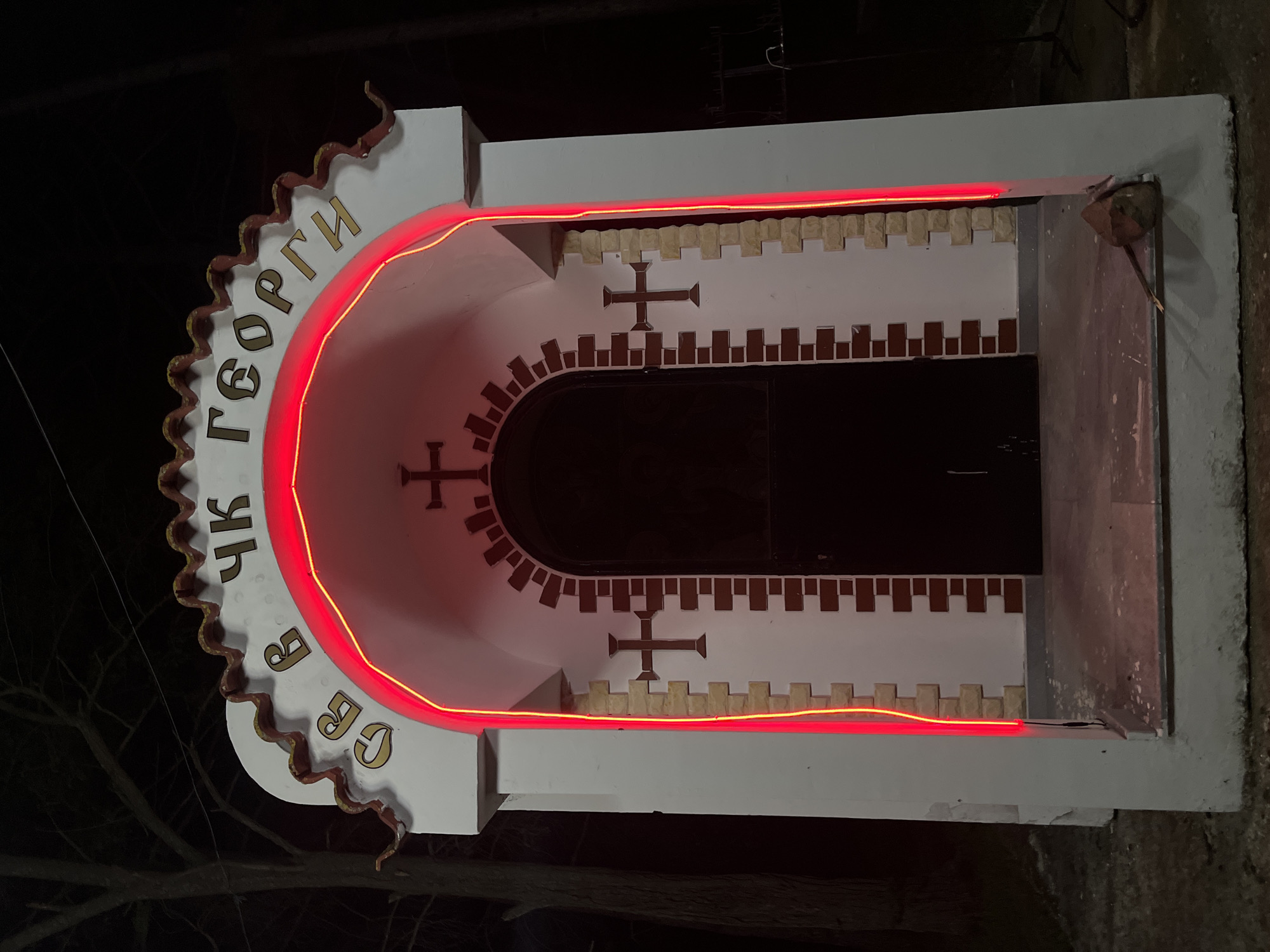 Religious monument glows with red lighting in Sungurlare, Bulgaria