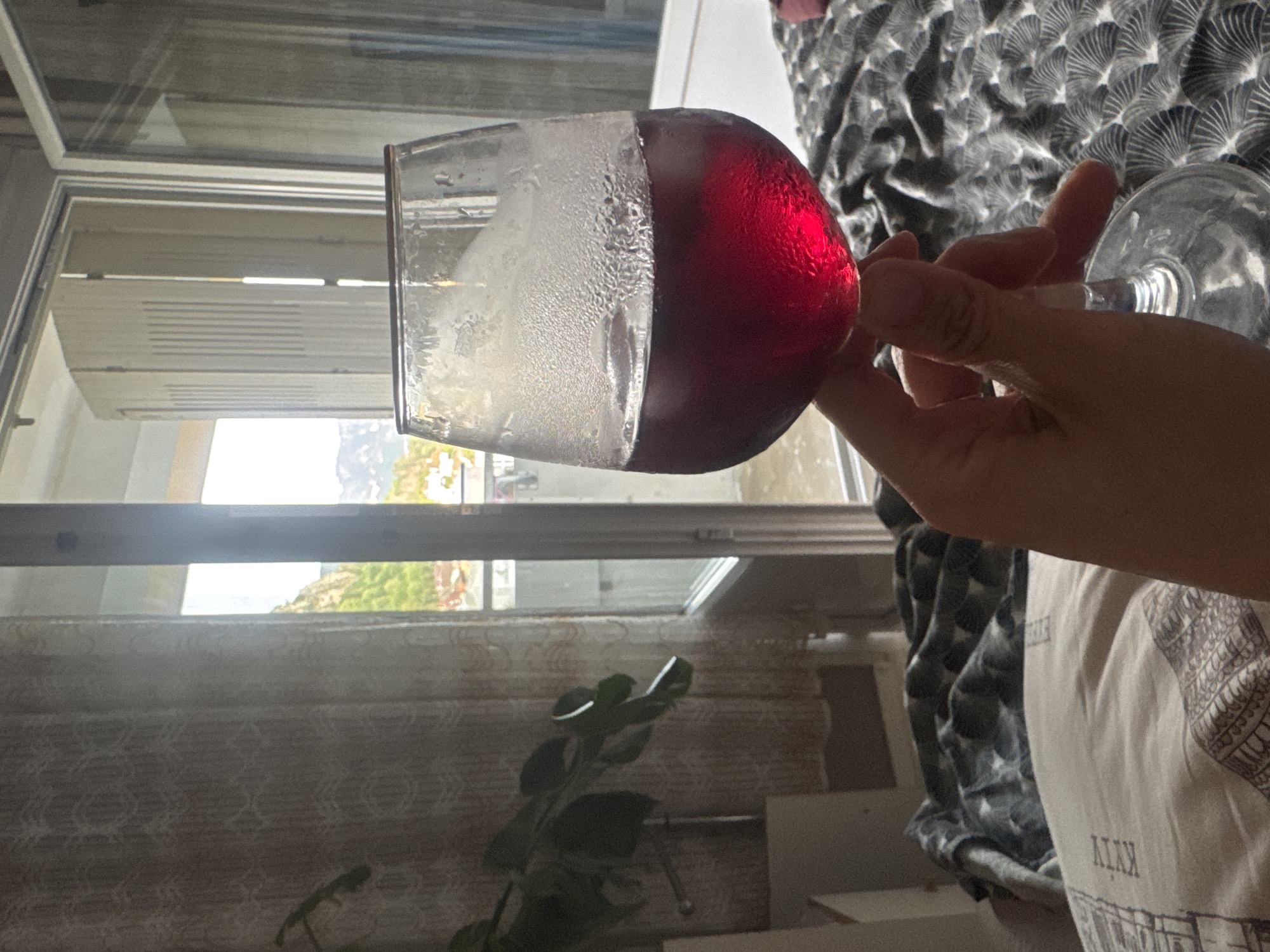 Chilled red wine in hand, Saint-Claude afternoon