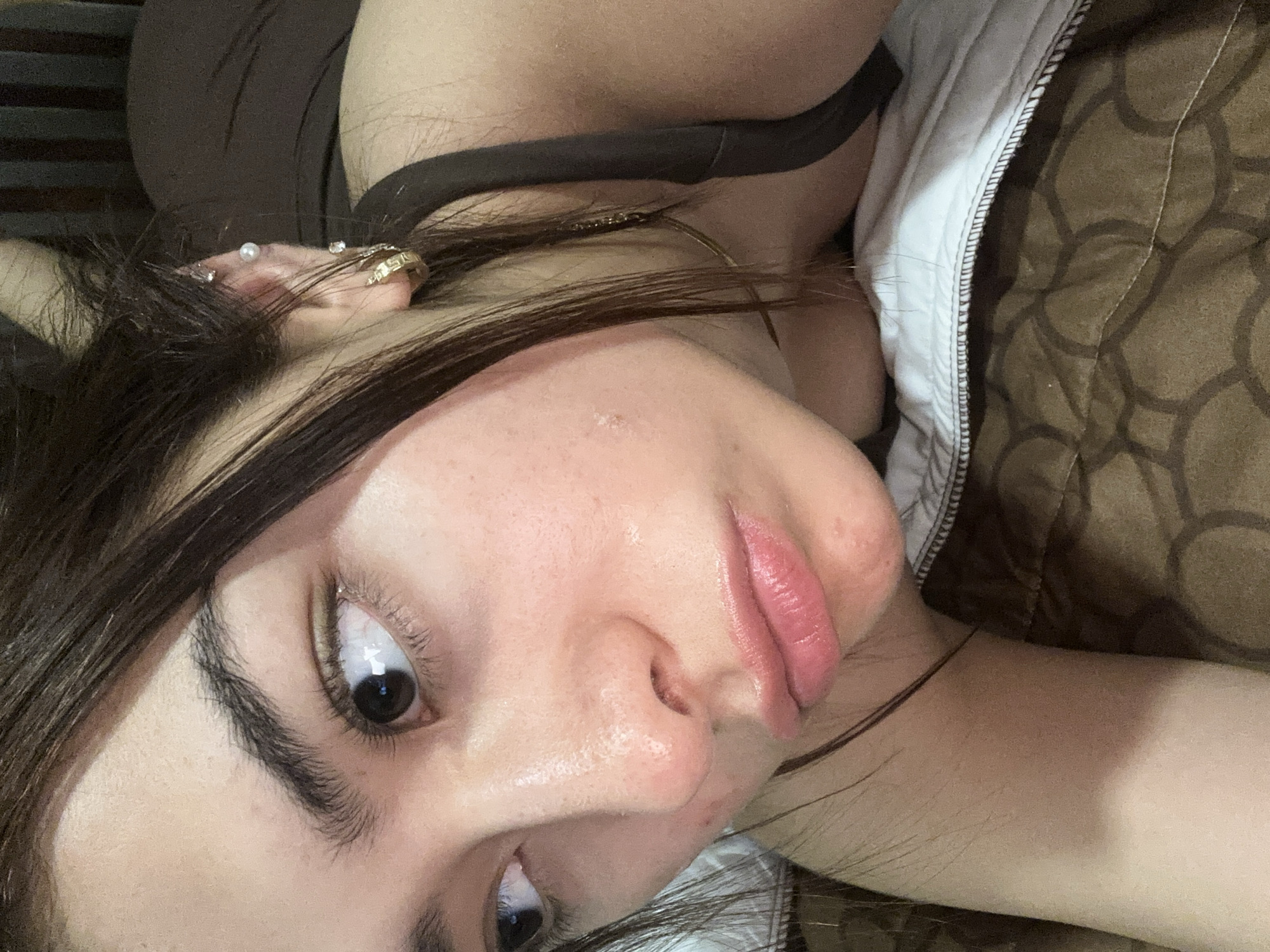 Woman with multiple piercings observed looking upward in Puebla