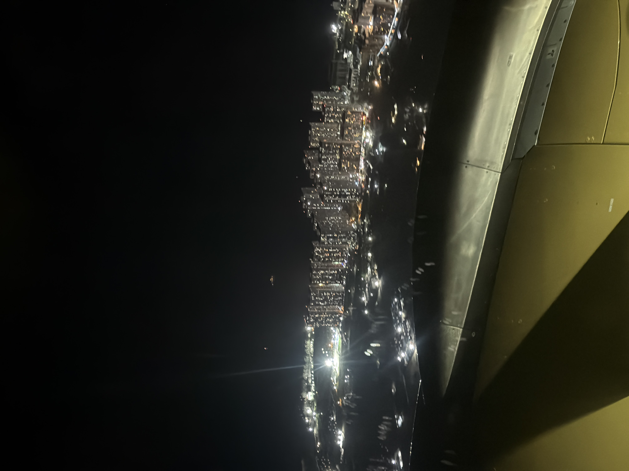 Nighttime aerial view of illuminated Malé captured from aircraft