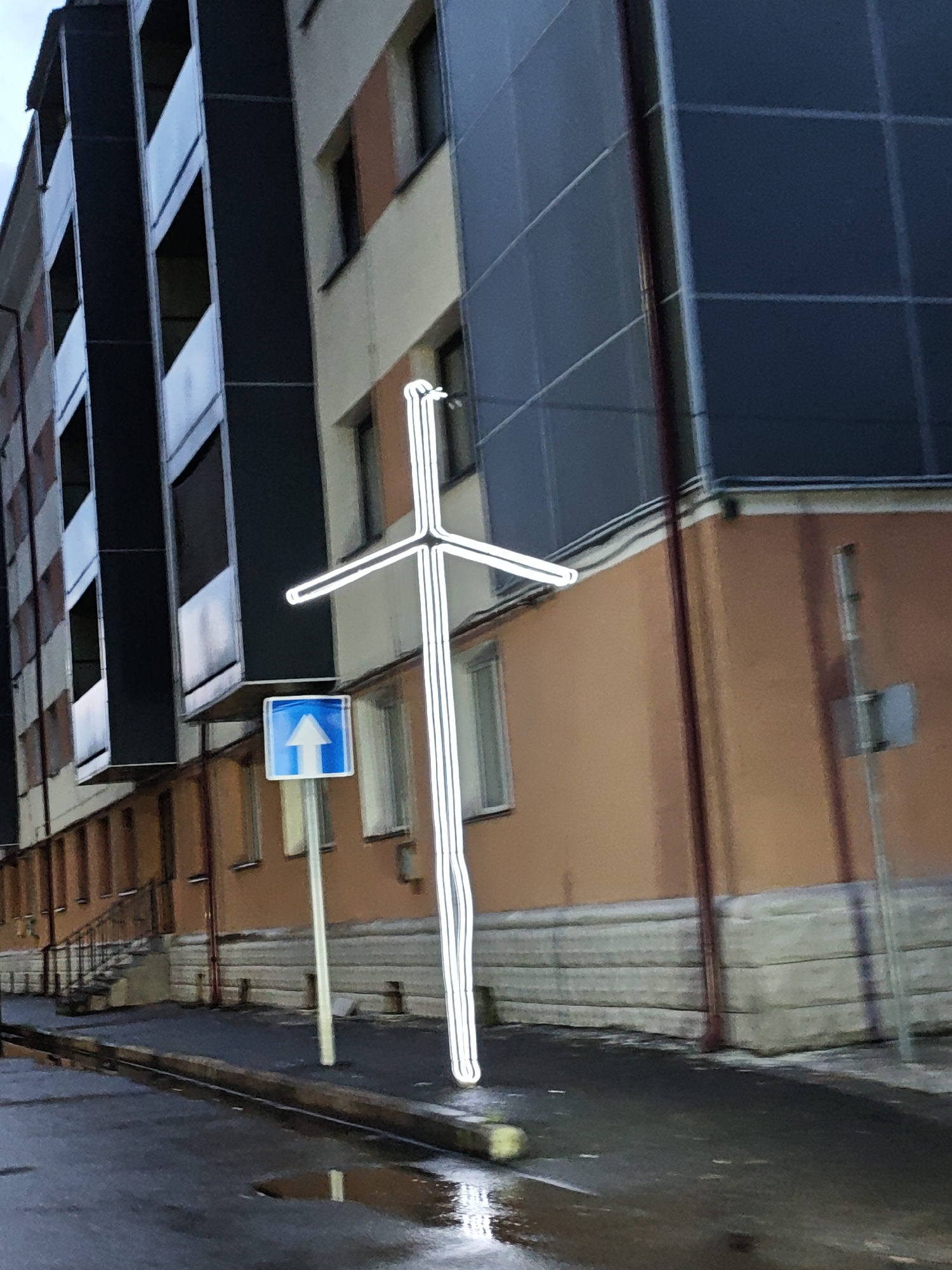 Wet streets and a glowing cross in Tqibuli, Georgia