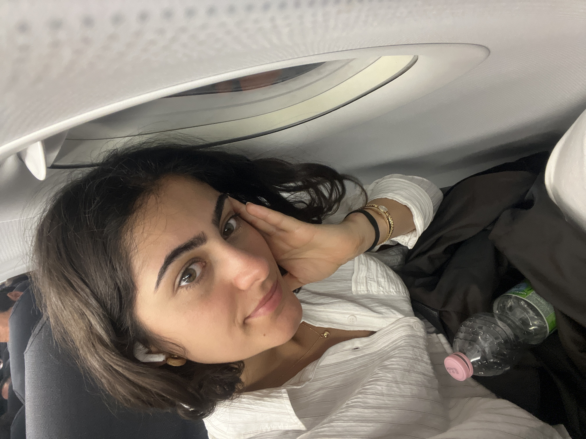 Woman rests aboard aircraft near Paris airport