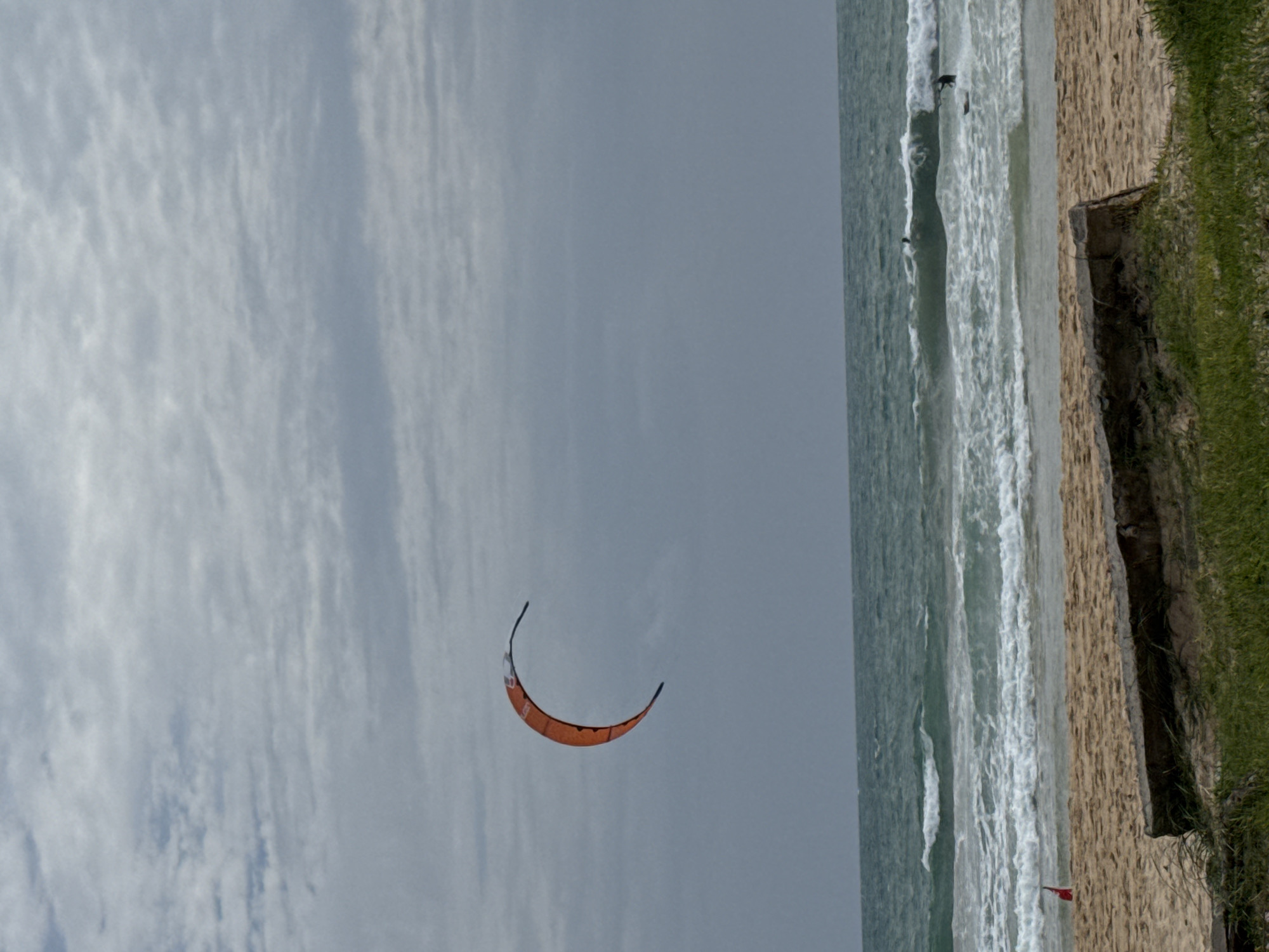 Overcast morning at Rawai Beach, kite flying, people relaxing