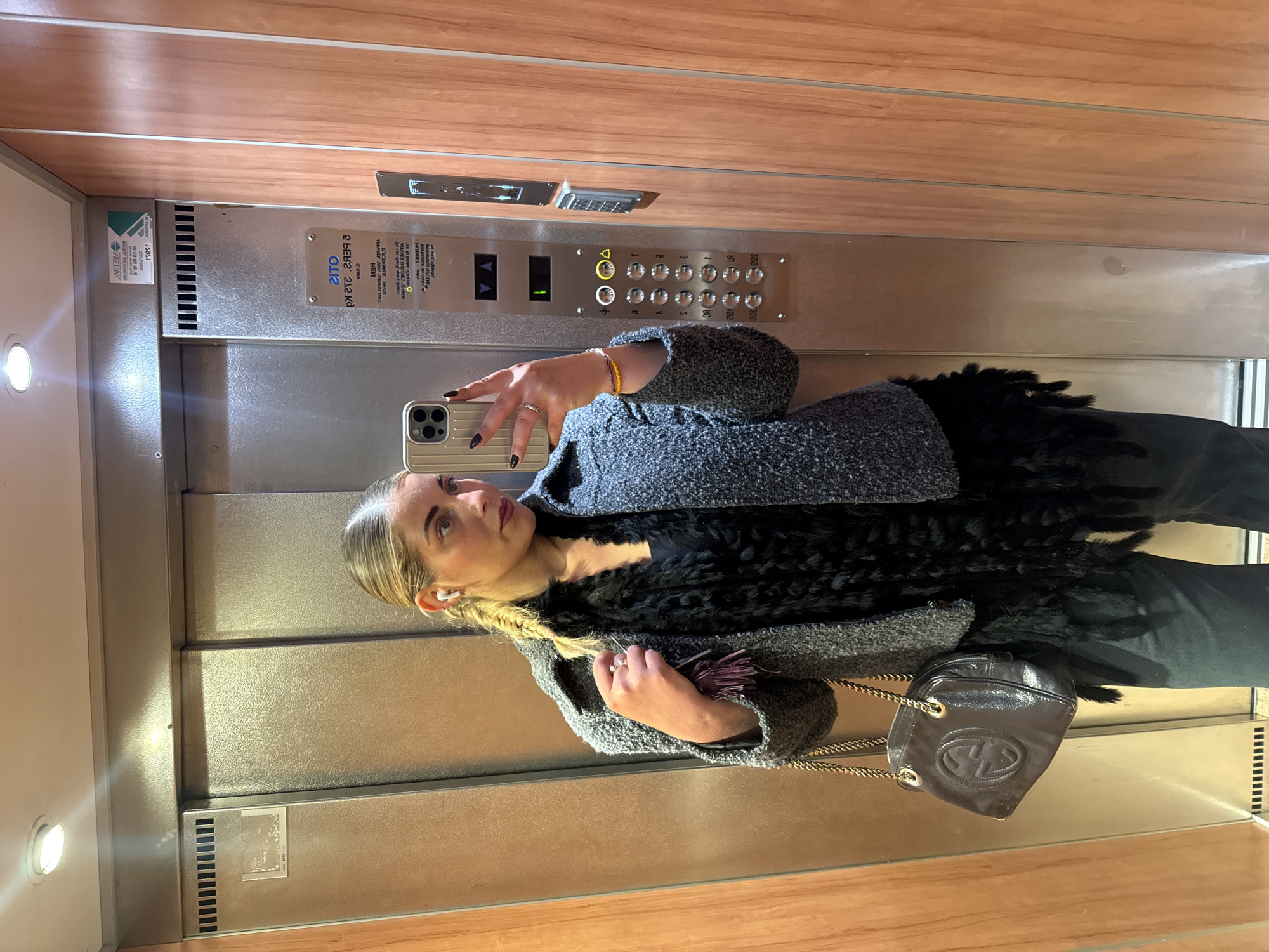 Woman takes selfies in Parisian elevator