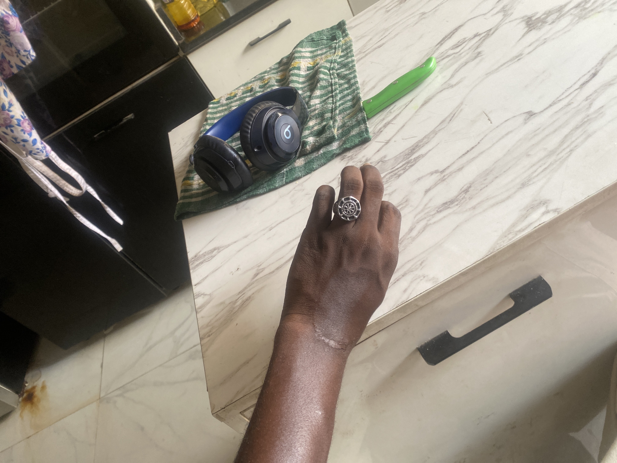 Domestic moment captured in Lagos showing hand with ring