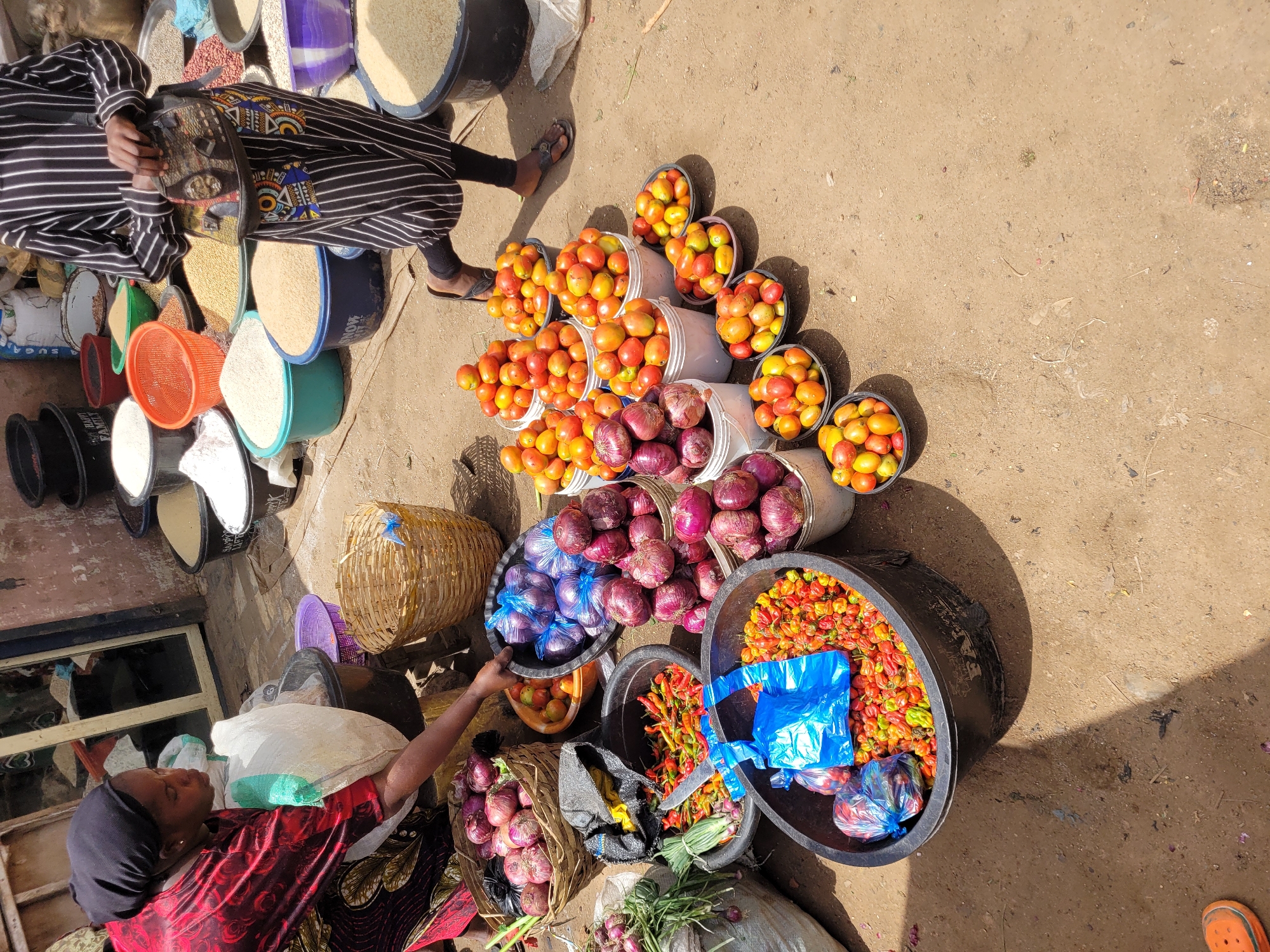 Bukuru market morning: street trade, loaded vehicles, everyday hustle