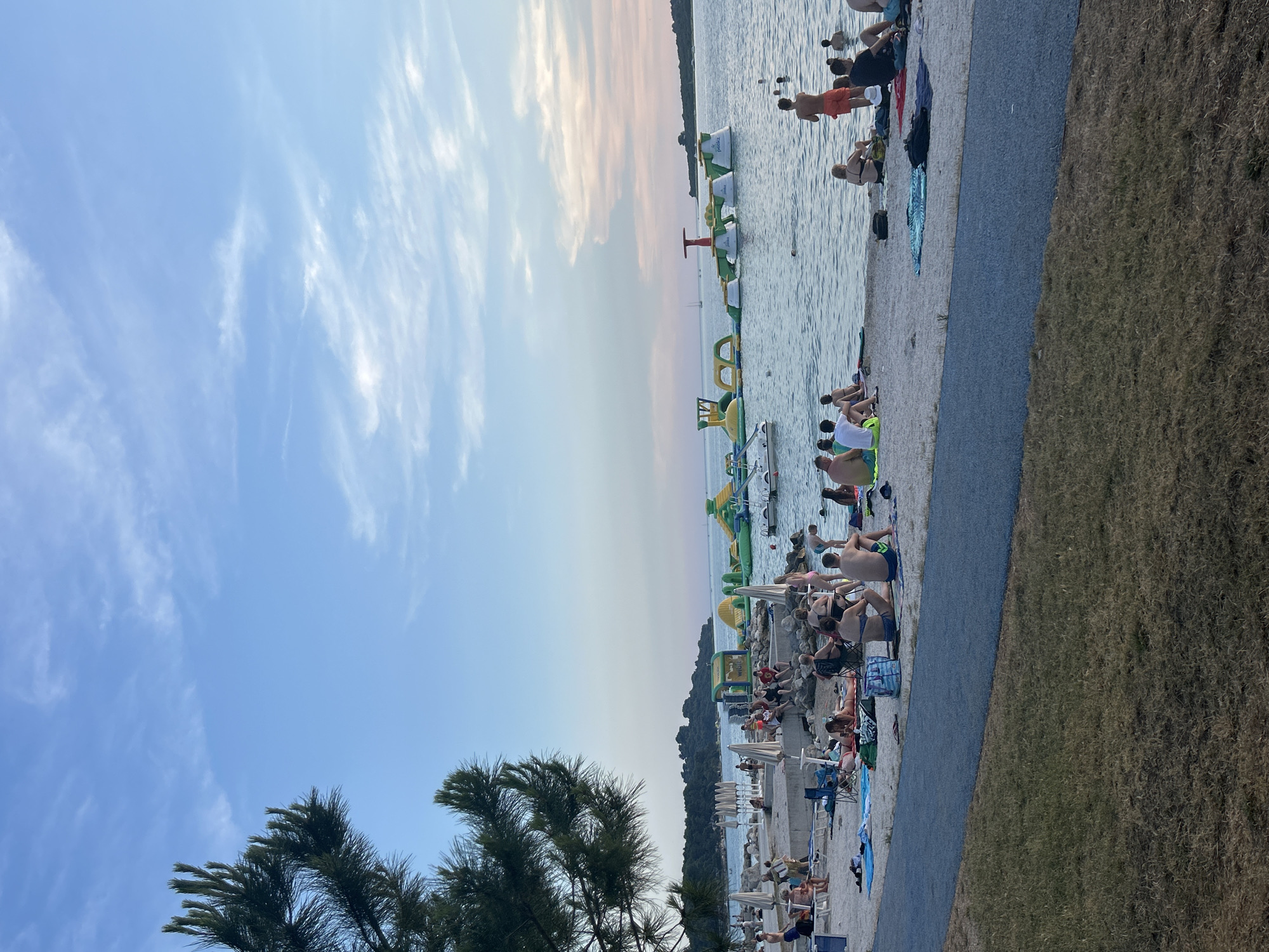 Sunset beach scene with people along the shore