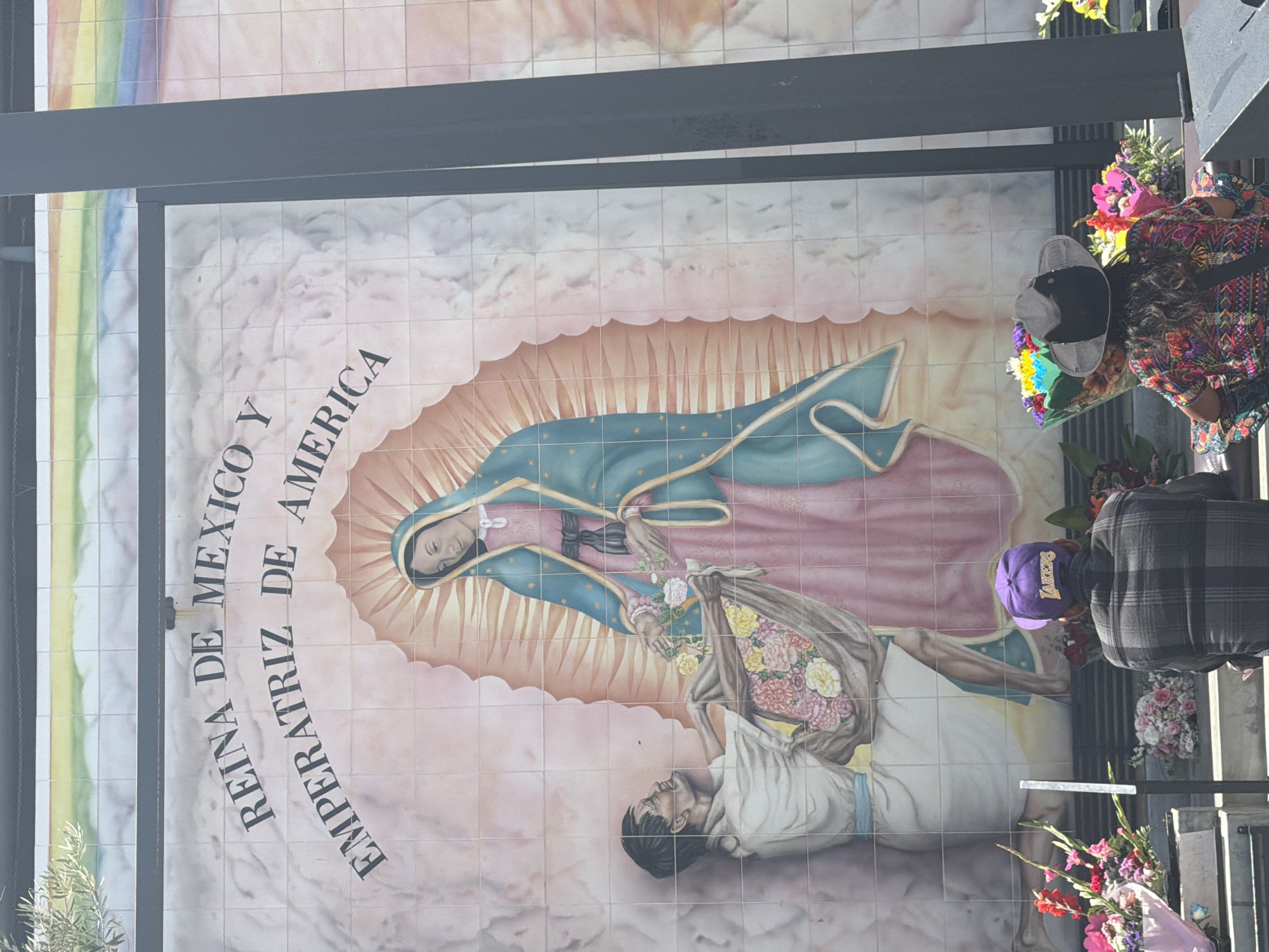 Visitor documents historical markers at El Pueblo monument