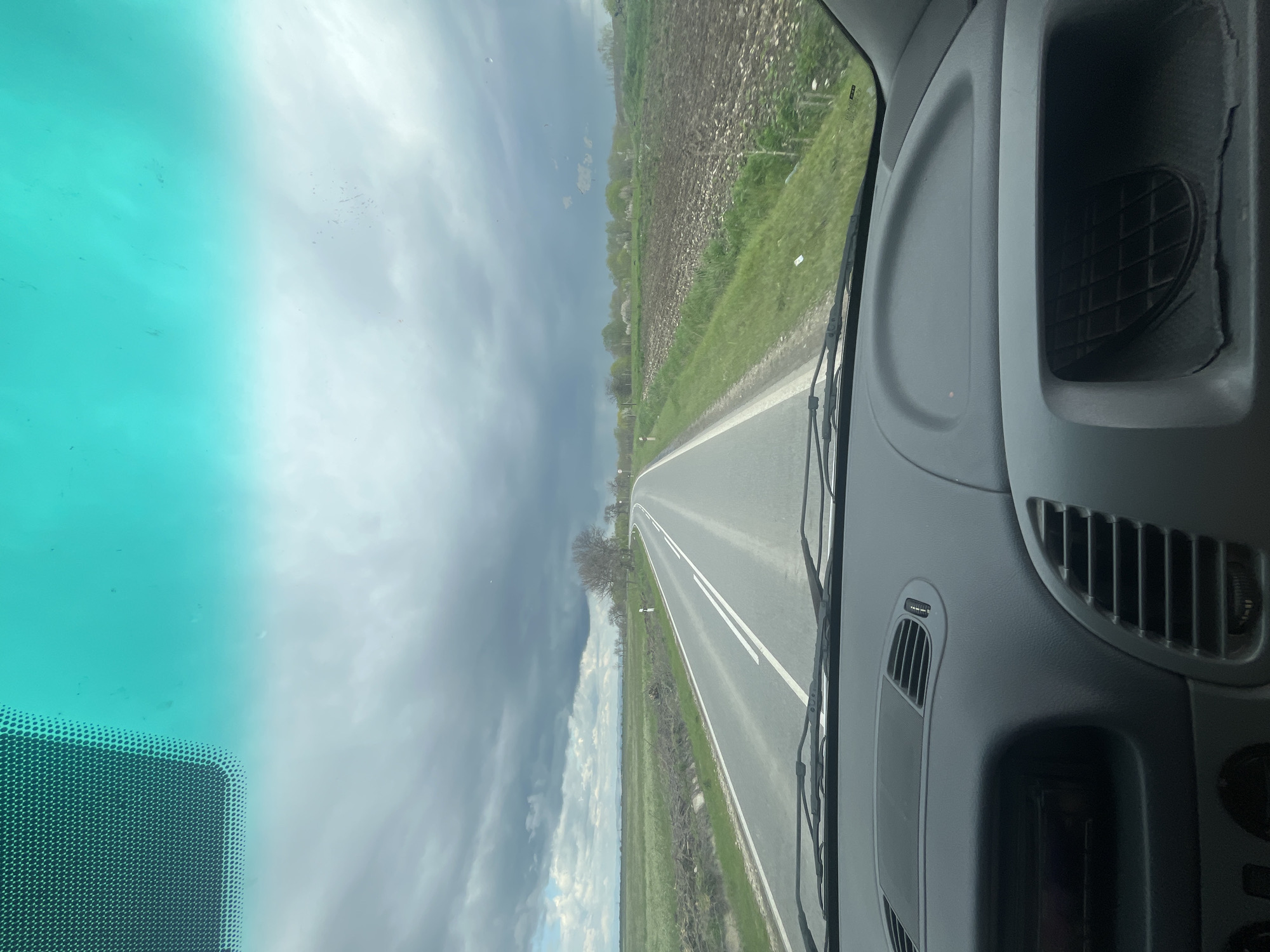 Vehicle travels rural road through Bulgarian countryside near Dalbok Izvor