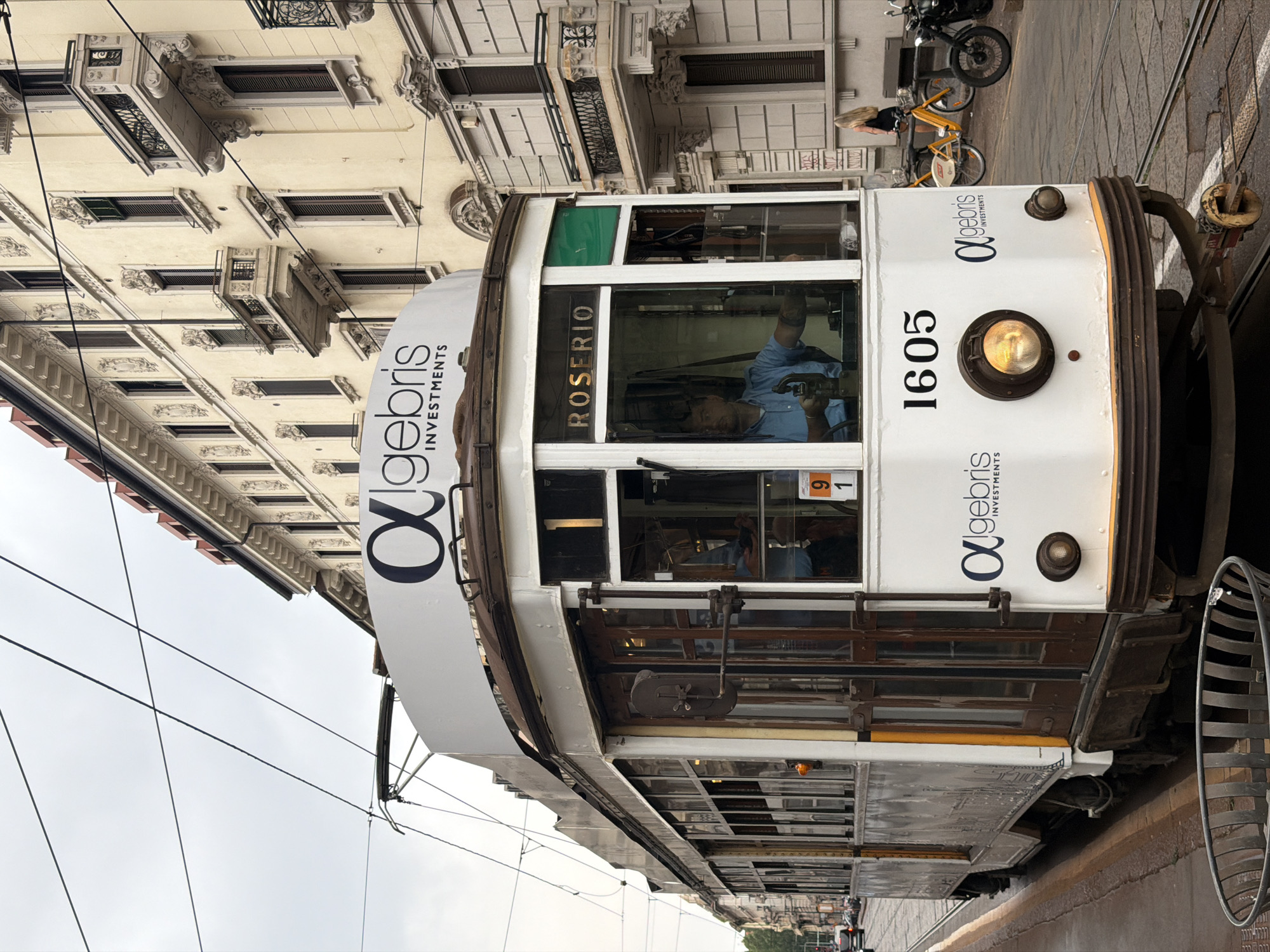 Milan tram 1605 rolls through a mix of old and new streetscapes