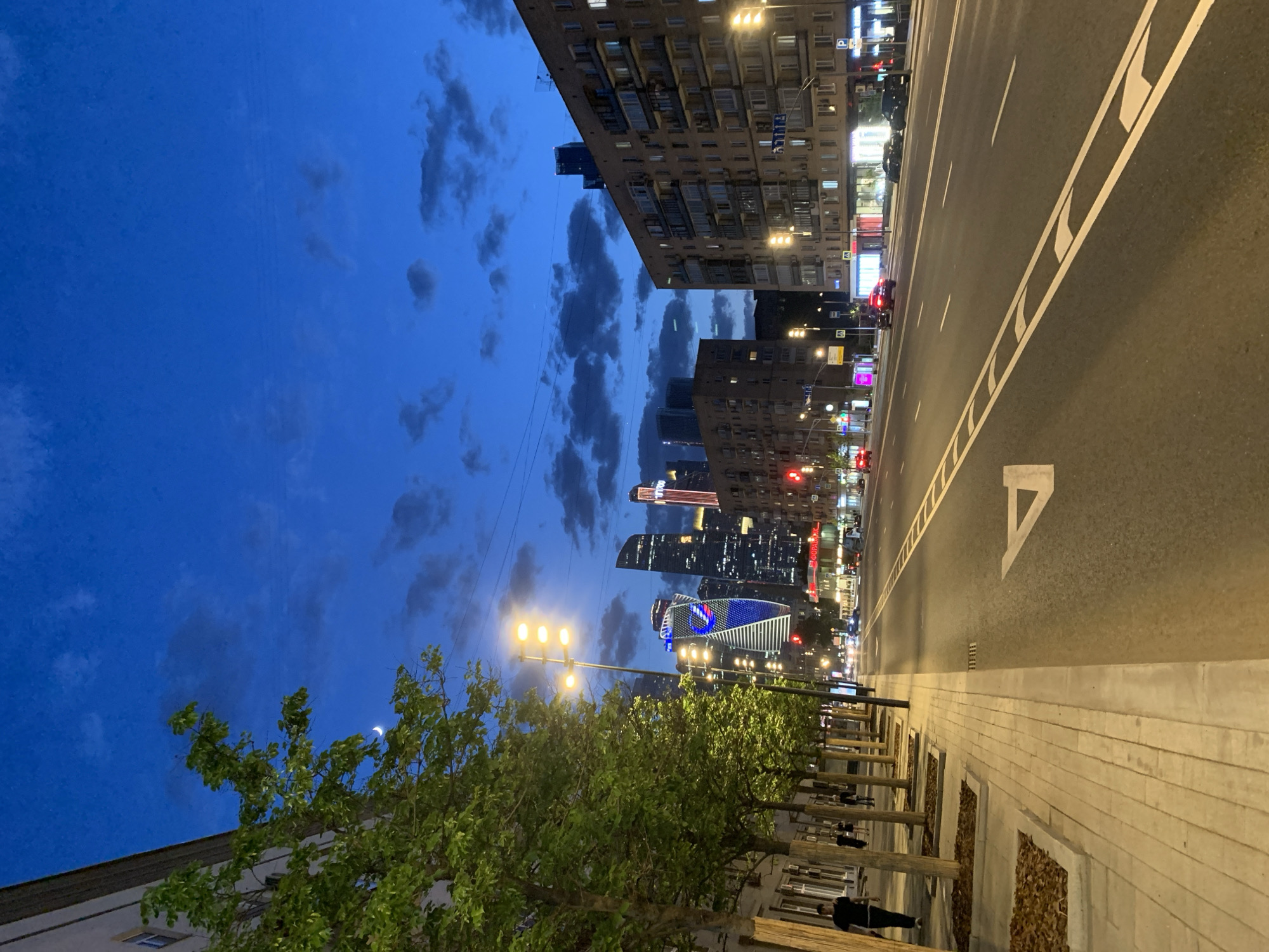 Evening street scene documented during dusk-to-night transition