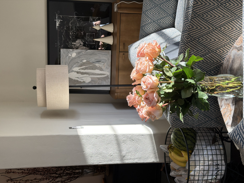 Pink roses arranged in glass vase observed in Los Angeles home