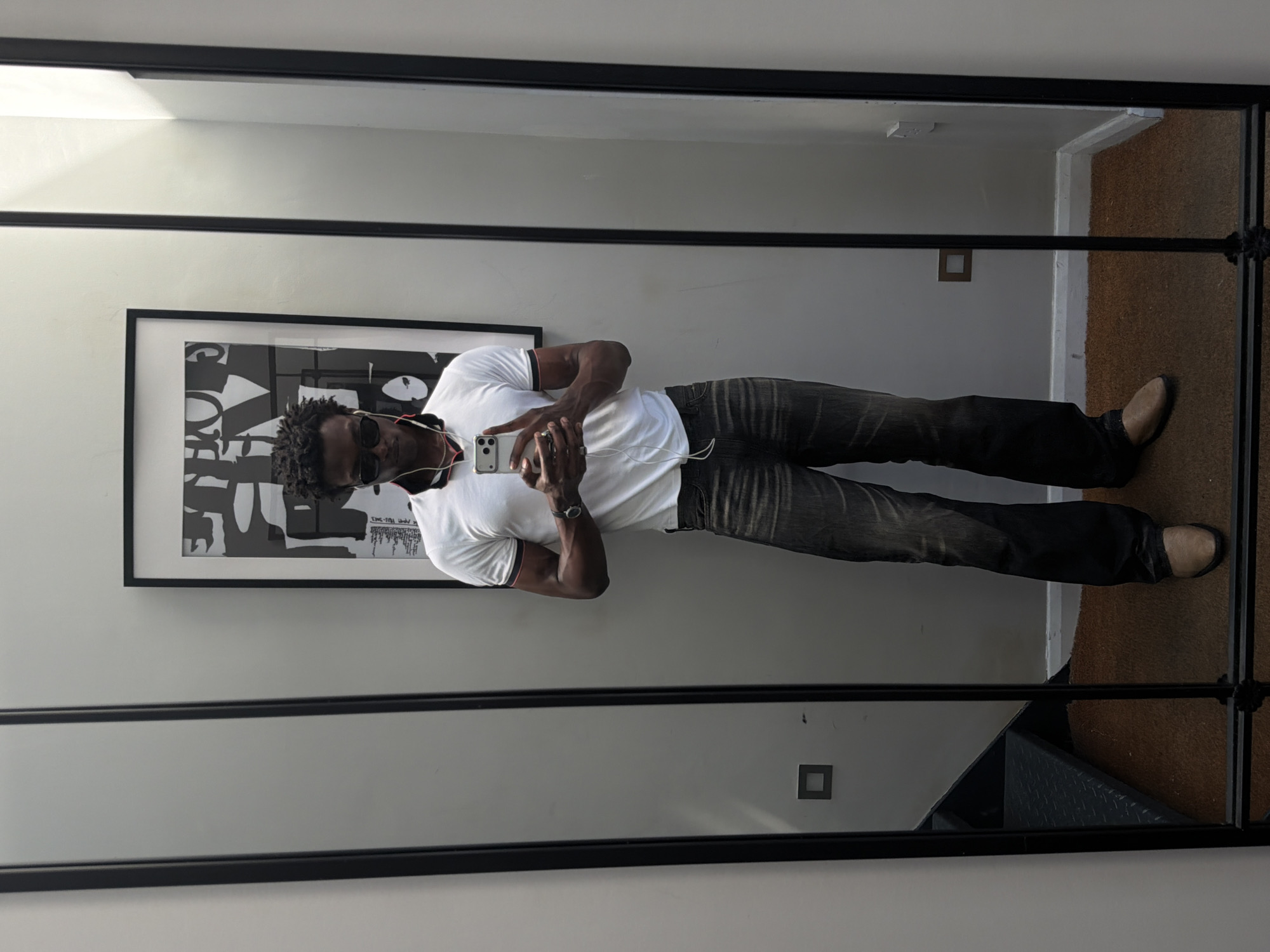 Mirror selfie in London: polo shirt and flared jeans