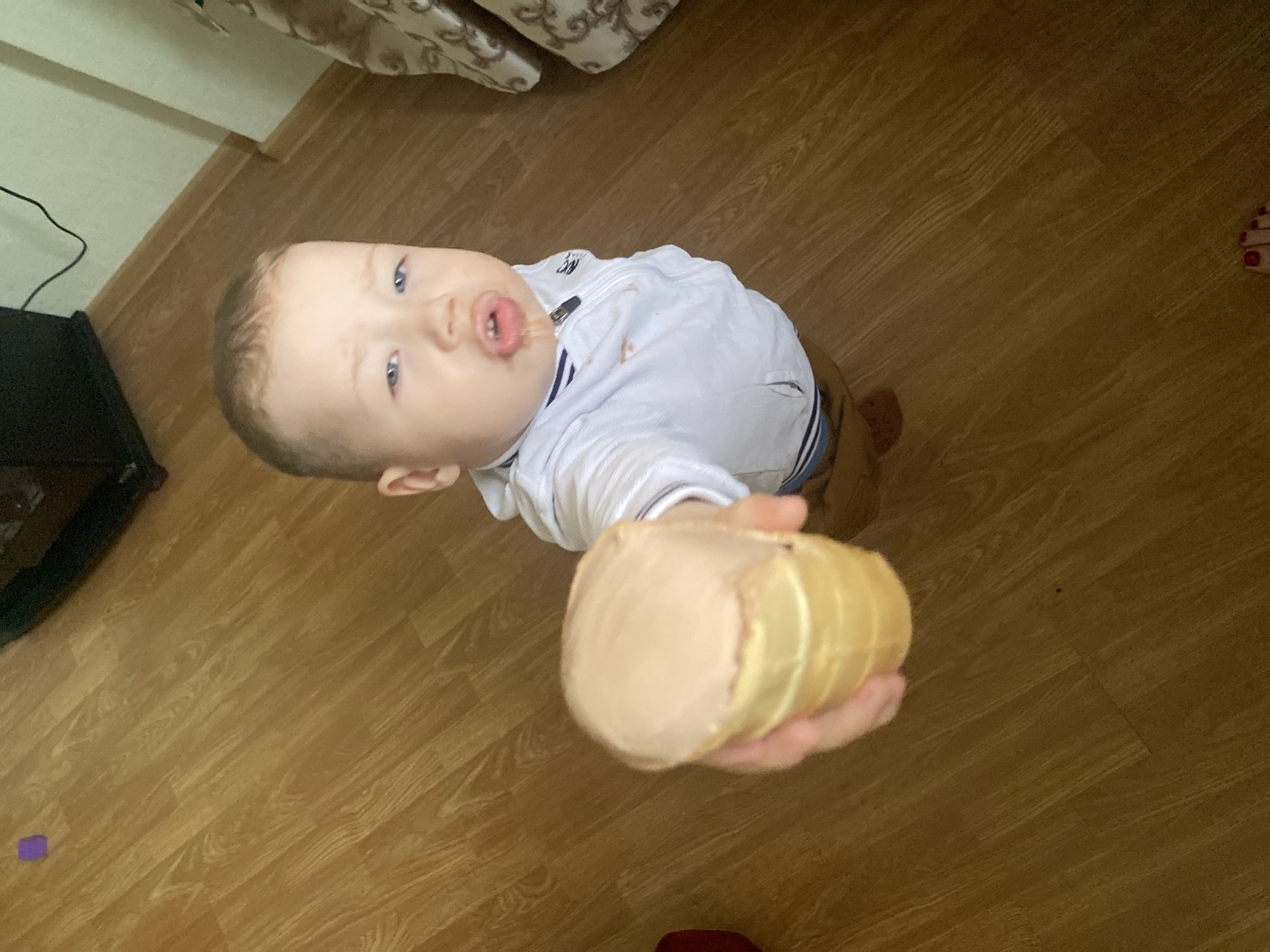 Child enjoys ice cream amid everyday Sochi street scenes
