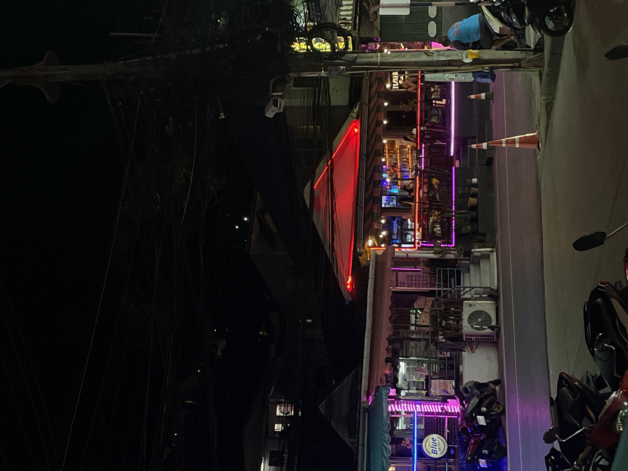 Neon nights, festival signage, and a dispensary shelf in Patong