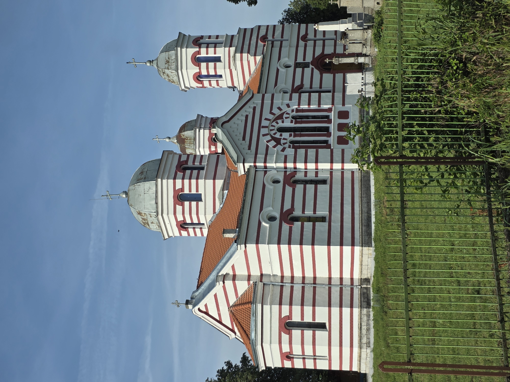 Distinctive striped church with multiple domes observed by witness