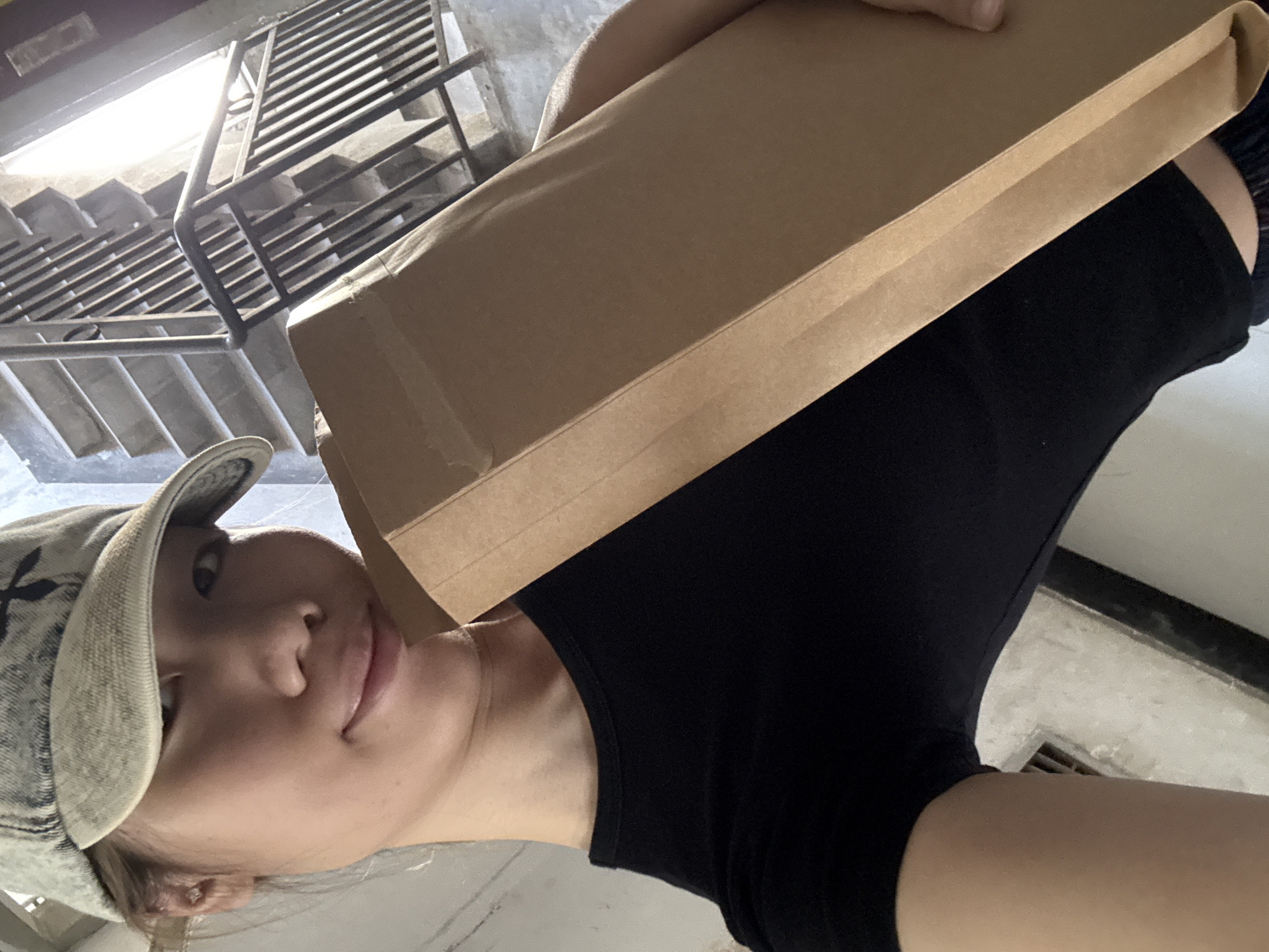 Cardboard box, paper bag, and a small dog in Shapingba