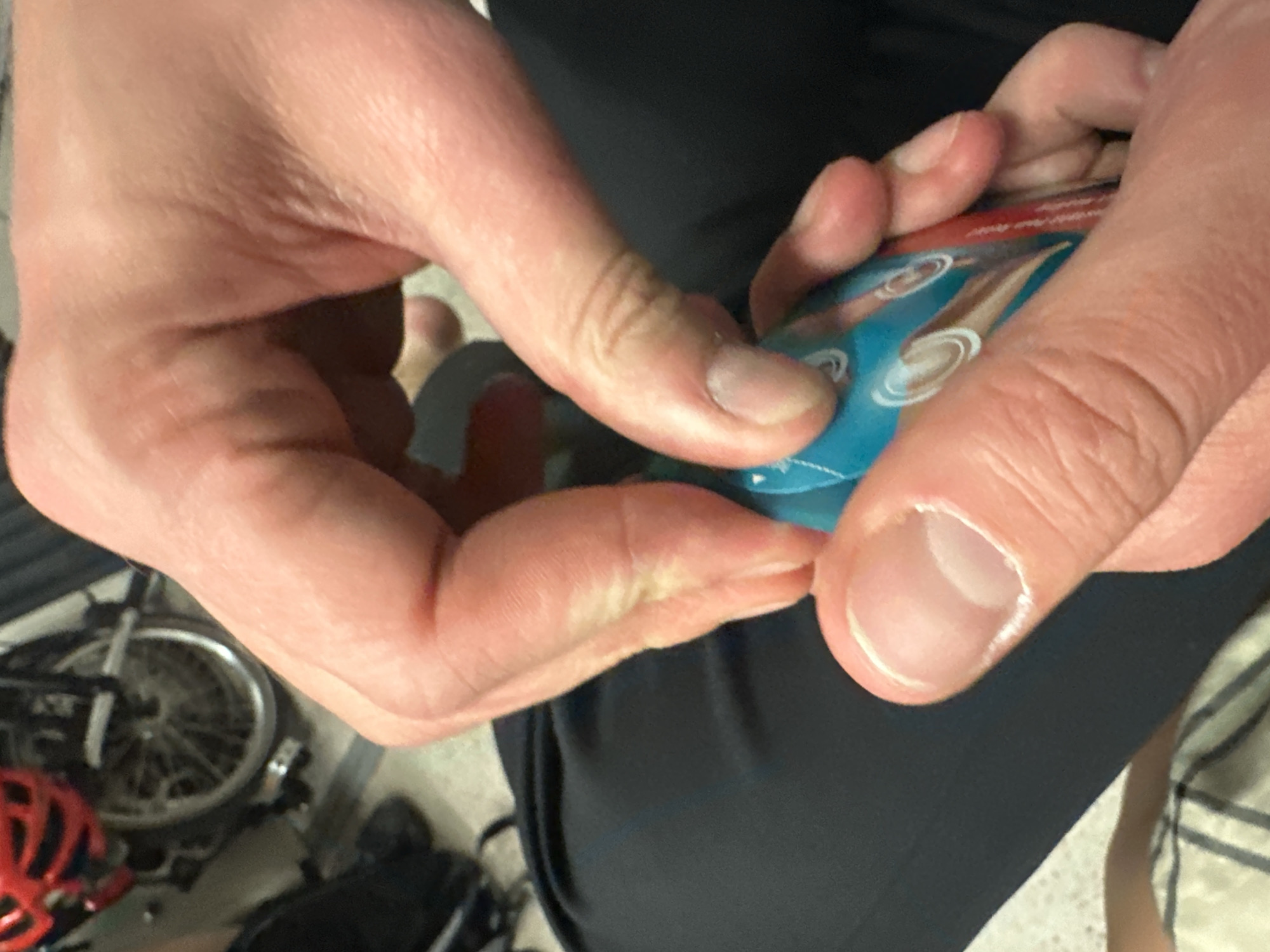 Person opens packet near bicycle at London pub area
