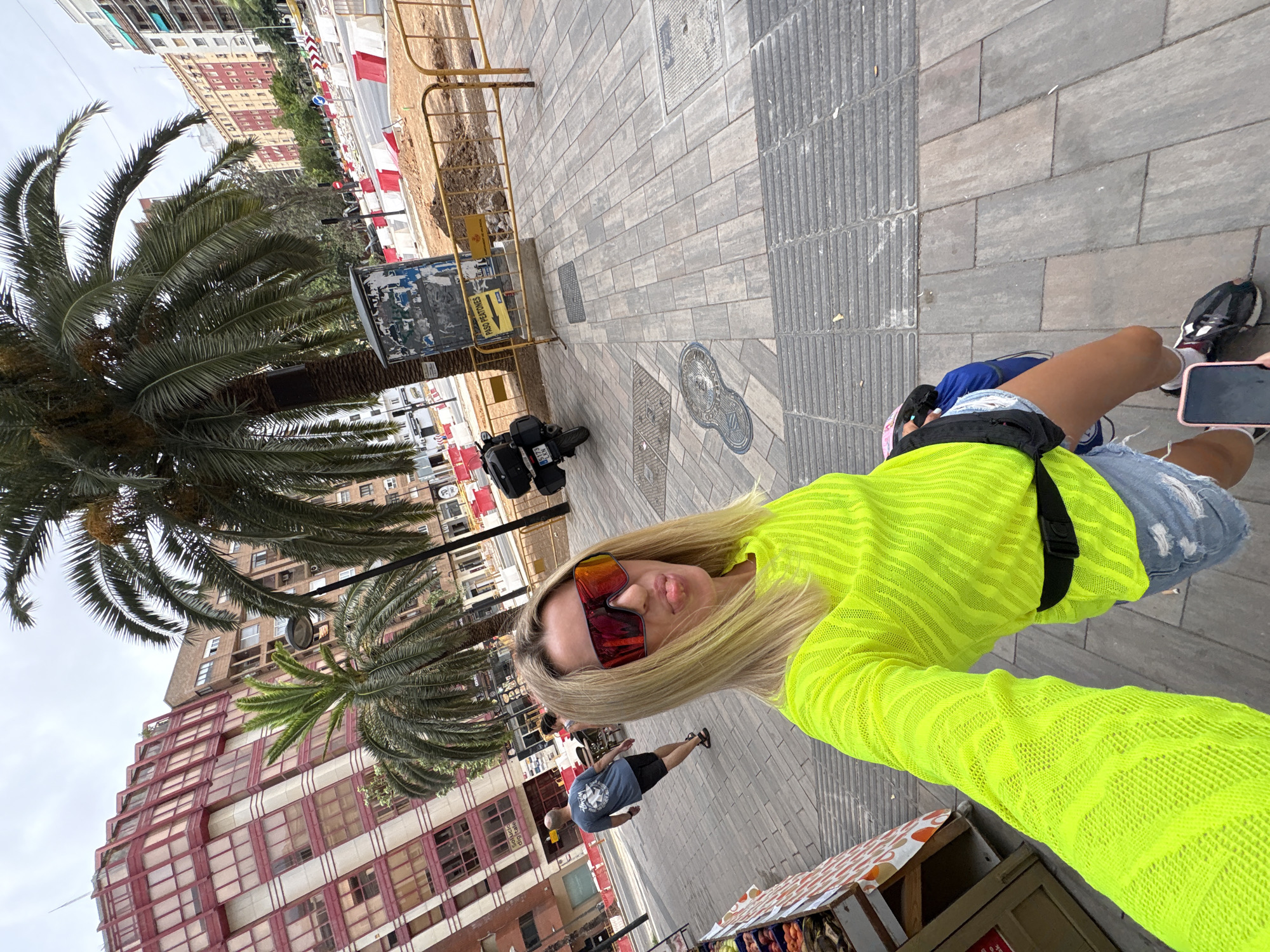 Valencia street corner: palms, café tables, and construction