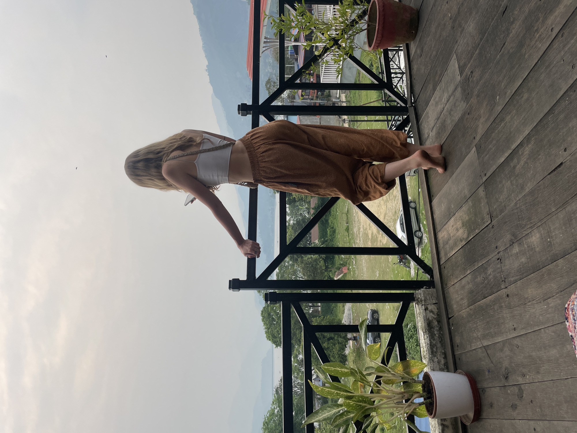 Woman observed on wooden balcony in Pokhara, Nepal