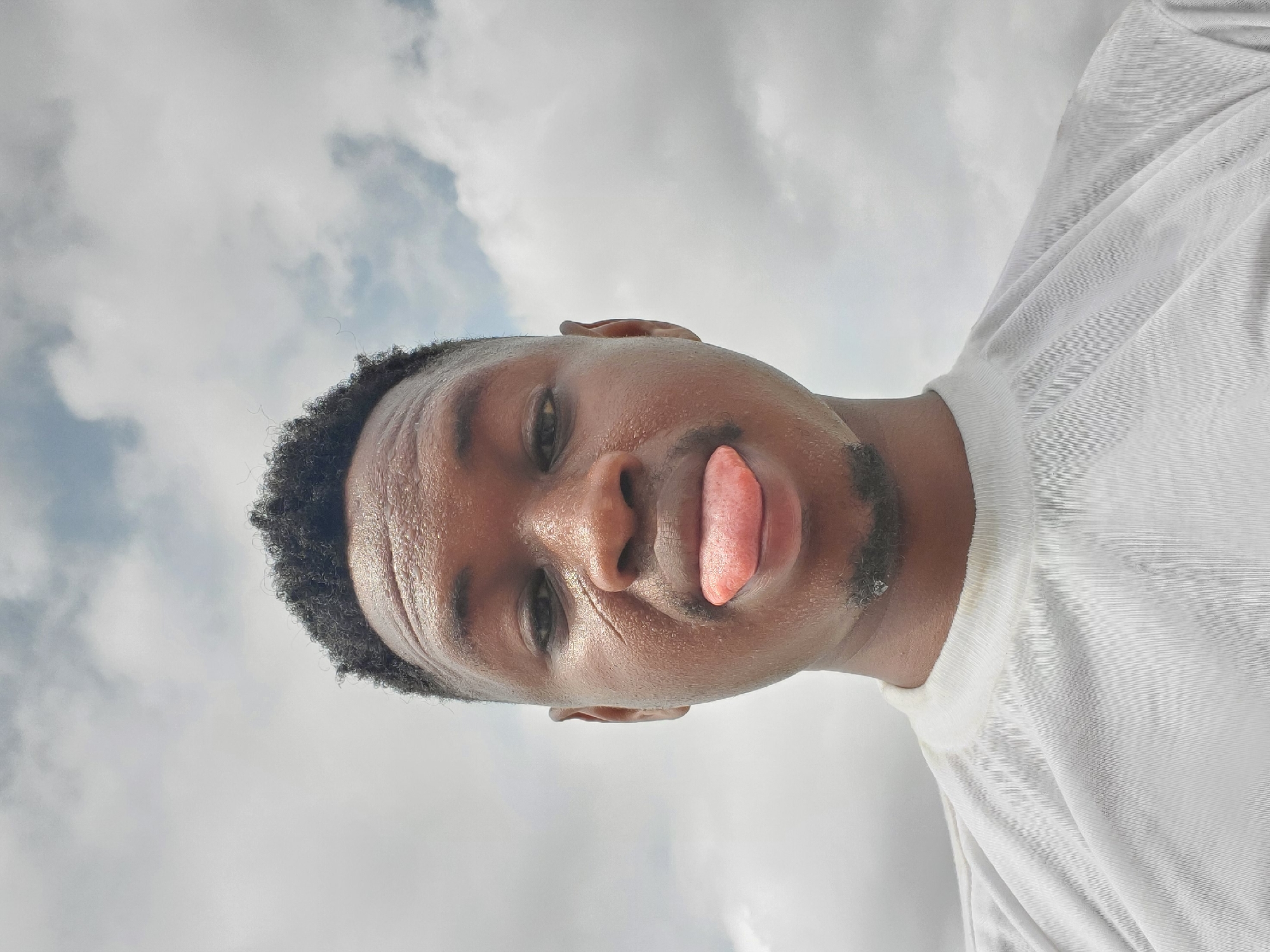 Man takes playful tongue-out selfie in Mararaba, Nigeria