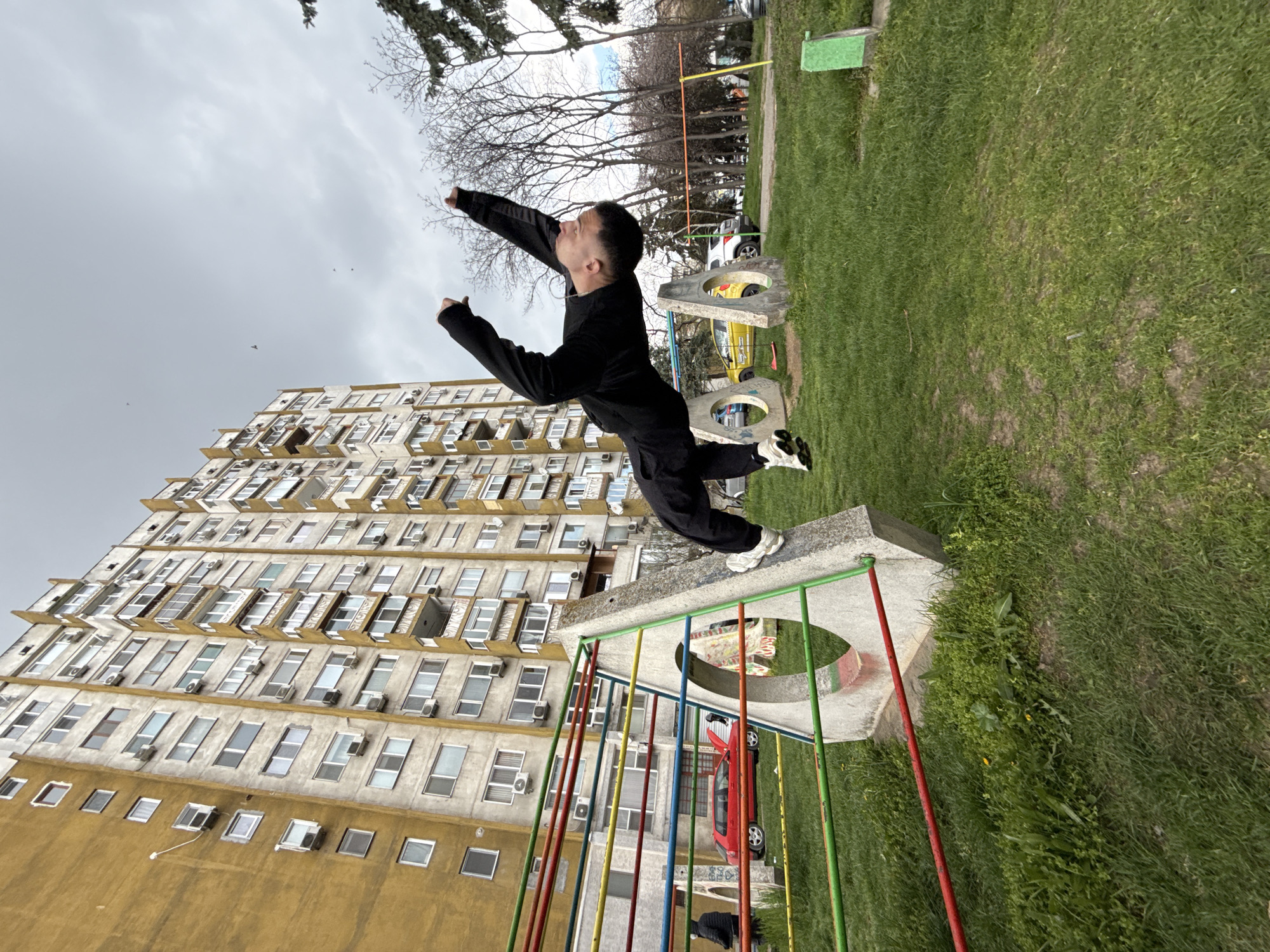 Person performs parkour jumps on playground structure in Shumen