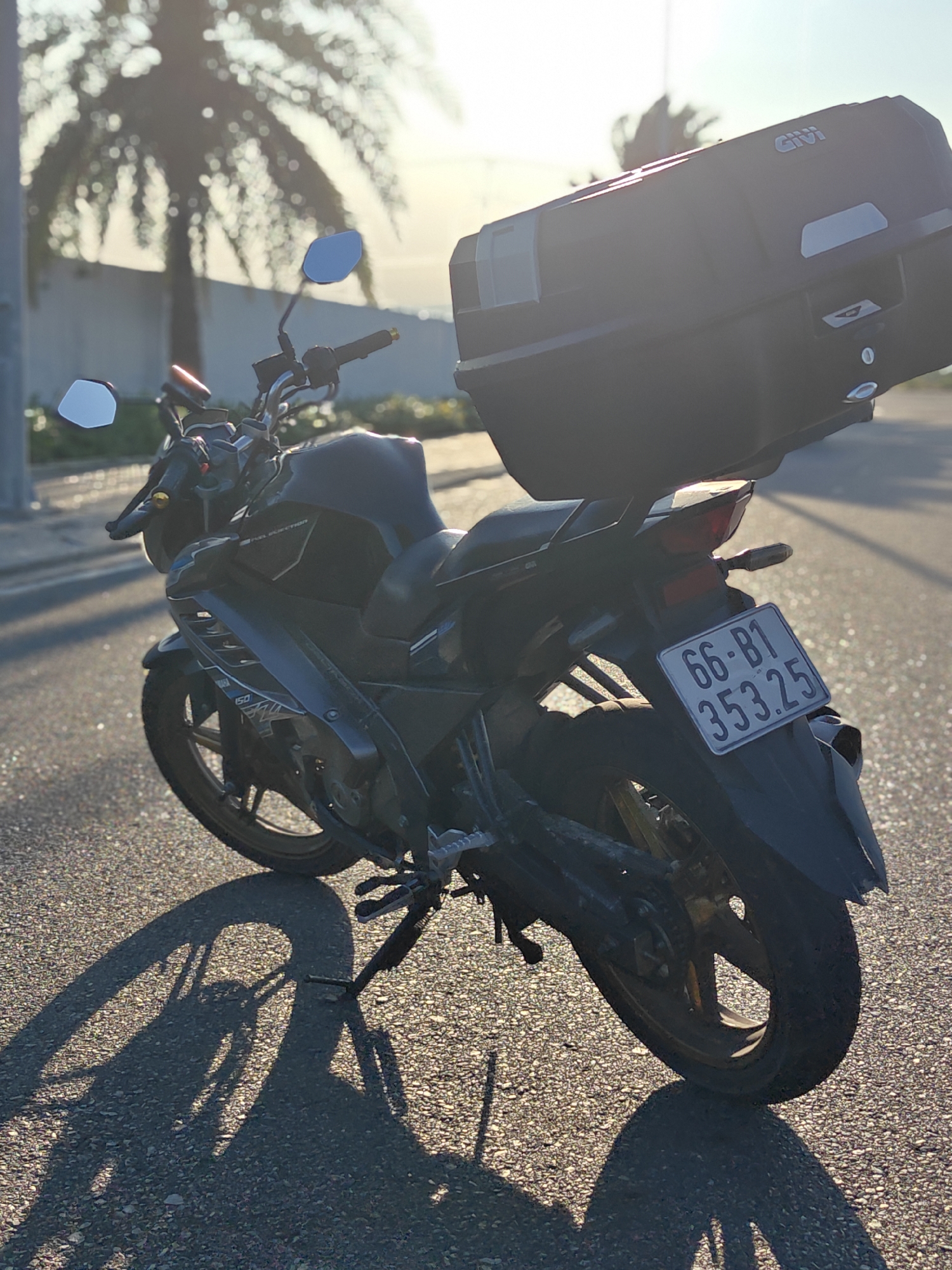 Black motorcycle with storage box parked in Cam Ranh