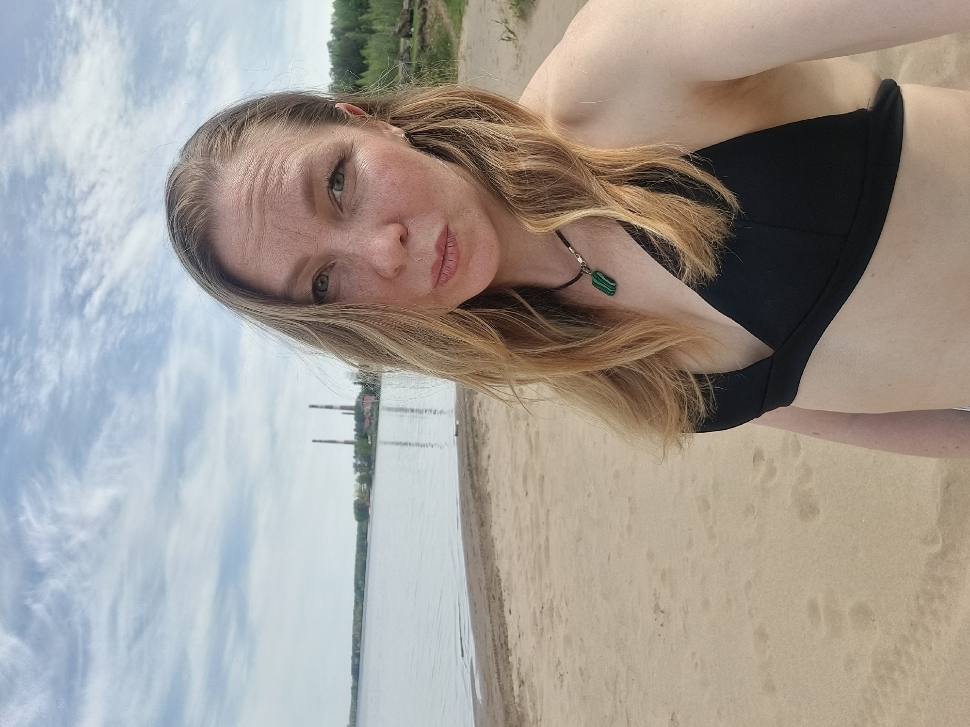 Woman sunbathes on Kama River beach in Chaikovsky, Russia