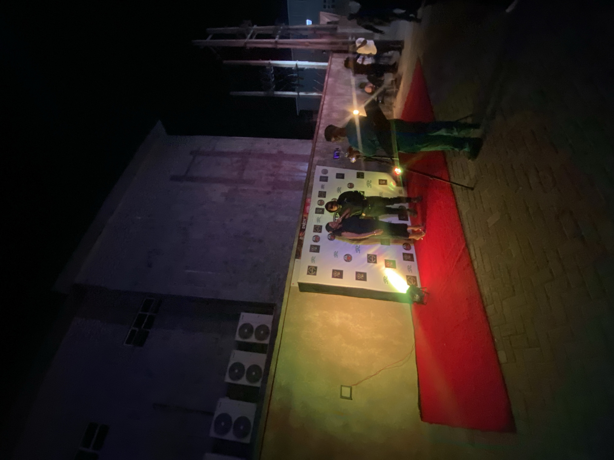 Evening at neon-lit bar in Iranla, Nigeria overlooks cityscape