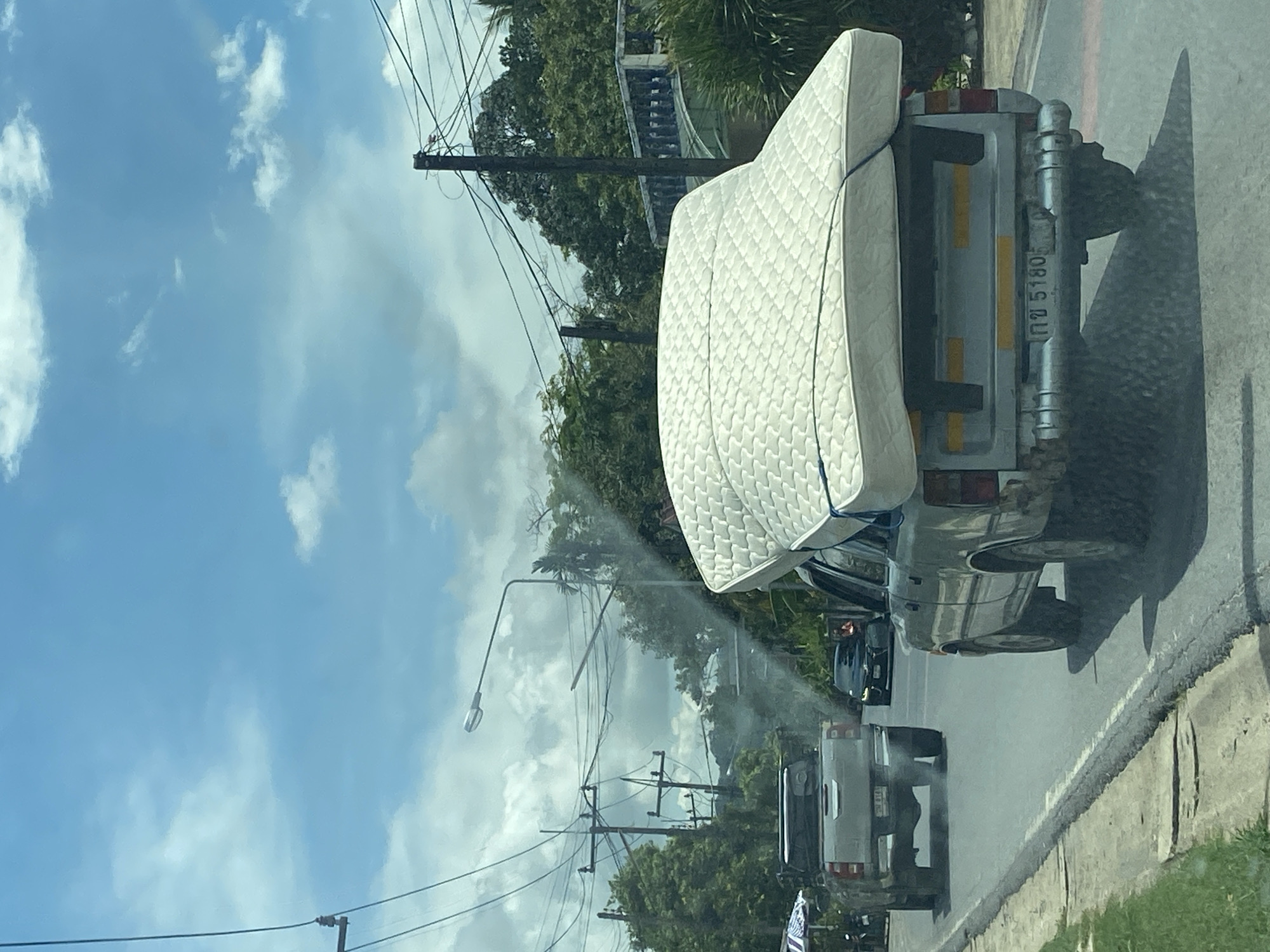 Pickup truck transports mattress on Si Sunthon road