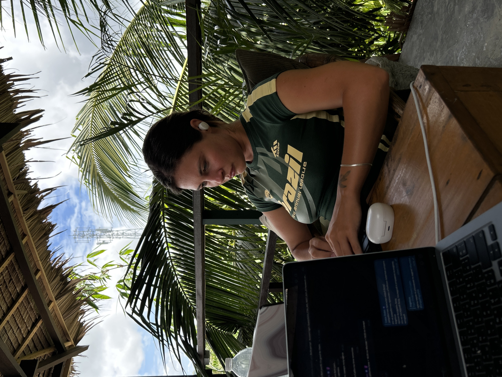 Woman works on laptop at Philippine cafe during early morning