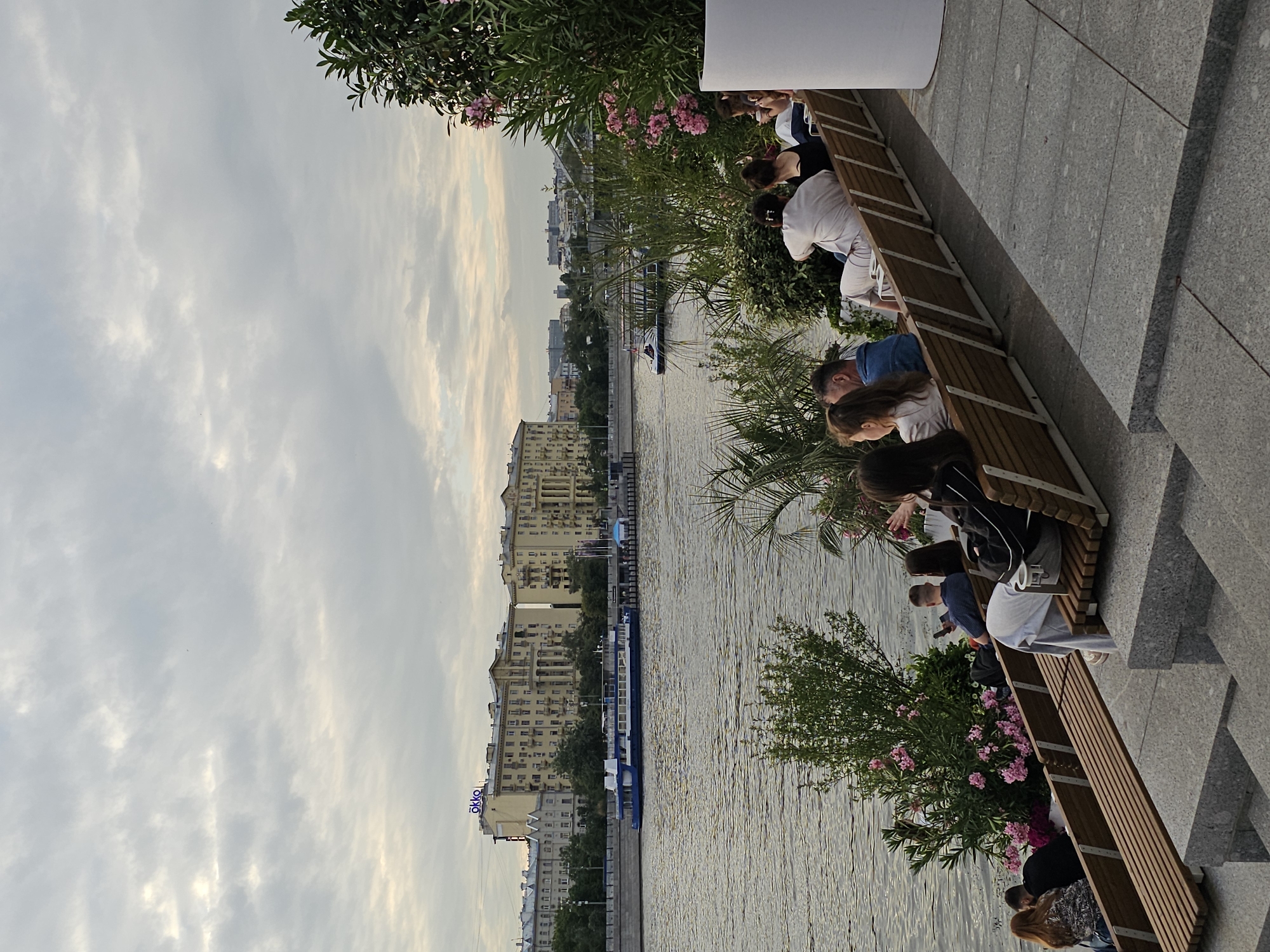 Afternoon along the Moskva River, benches, boats, and dusk skyline