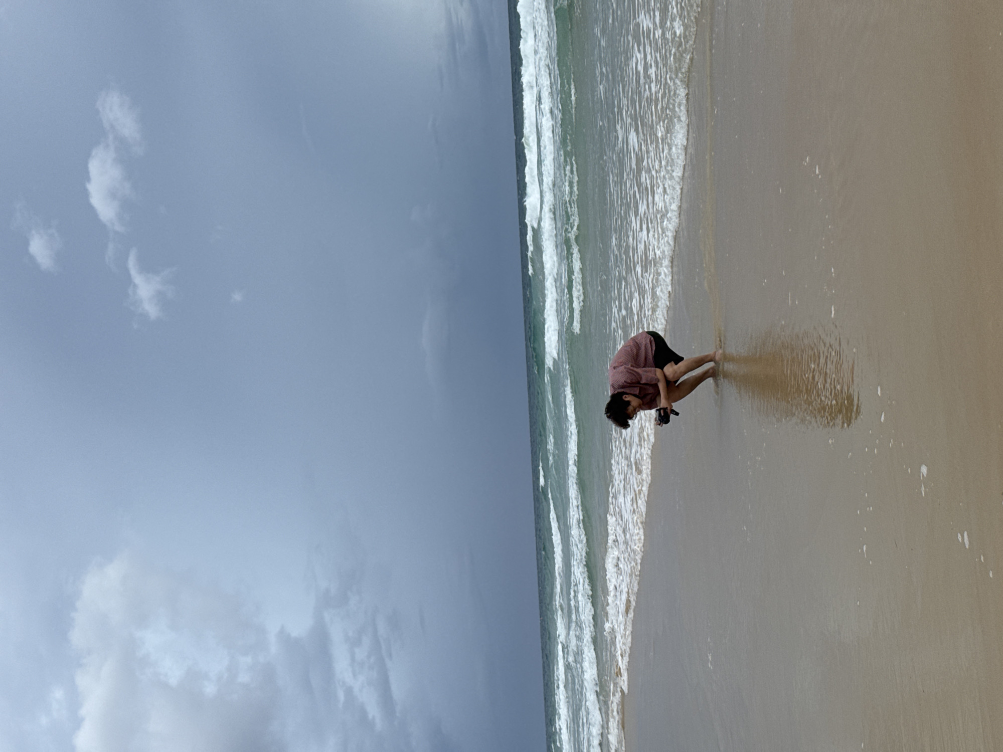 Karon Beach stays busy under stormy skies, flags and all