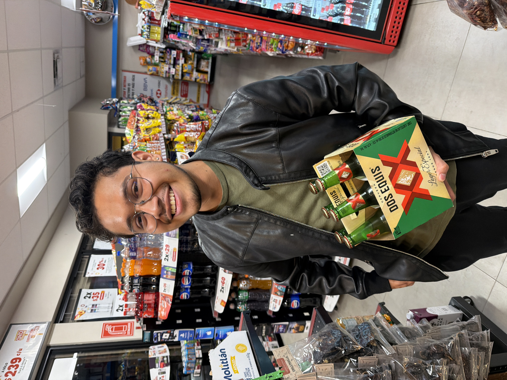 Man buys beer at OXXO convenience store in Cholula