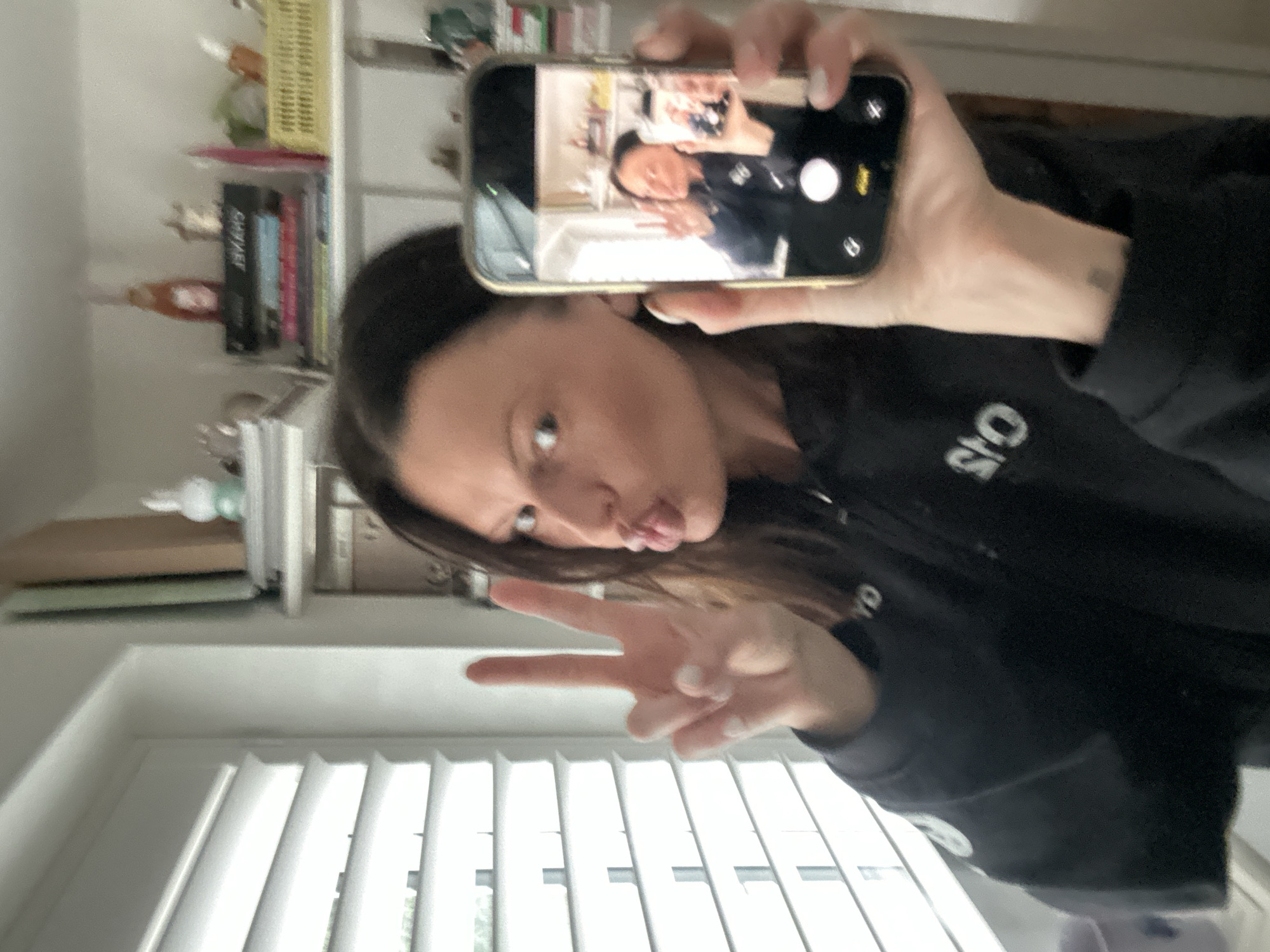 Woman takes selfie with peace sign in Wealden home