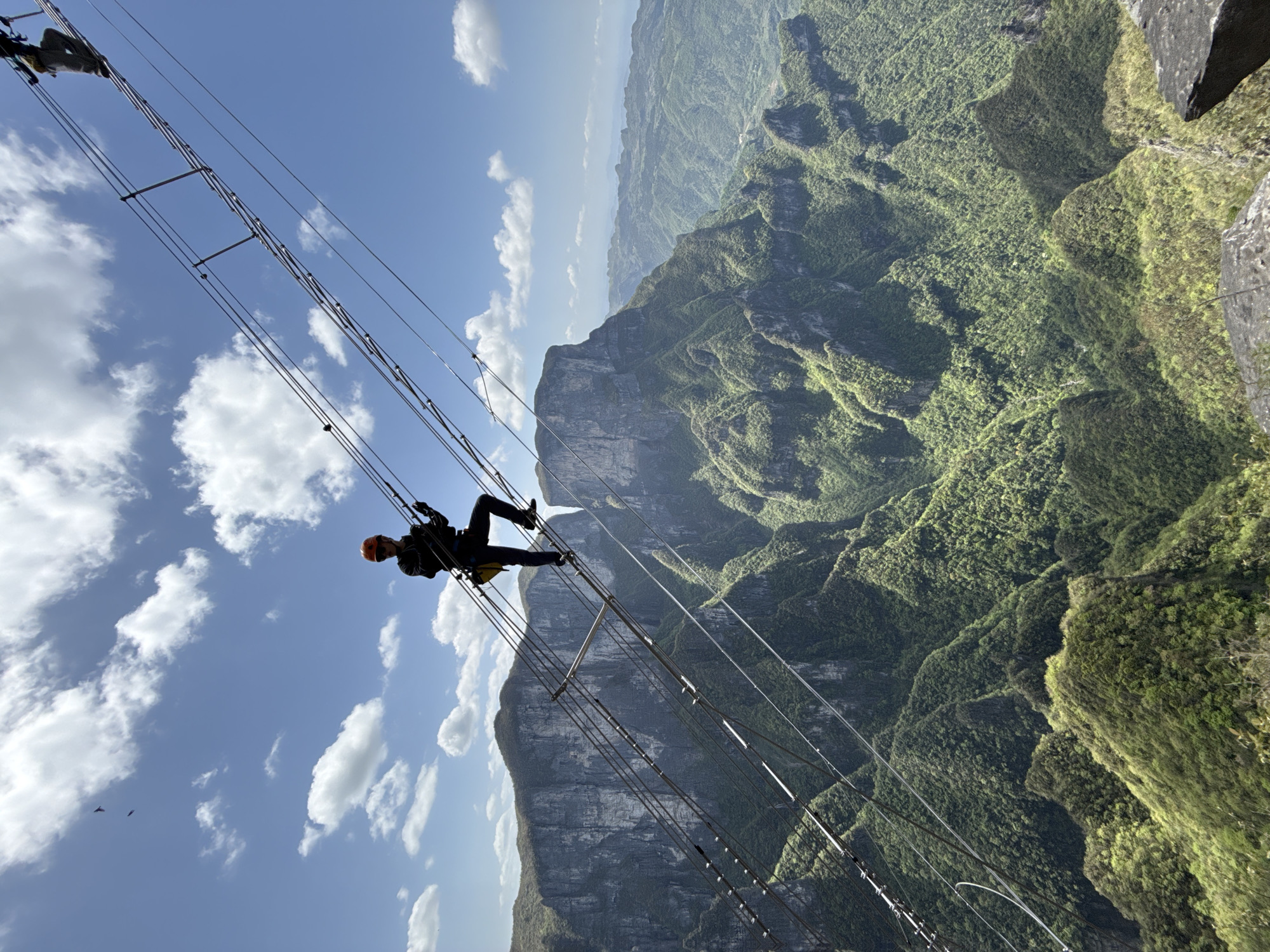 Morning climbers navigate suspension bridges, via ferrata routes in Yongding