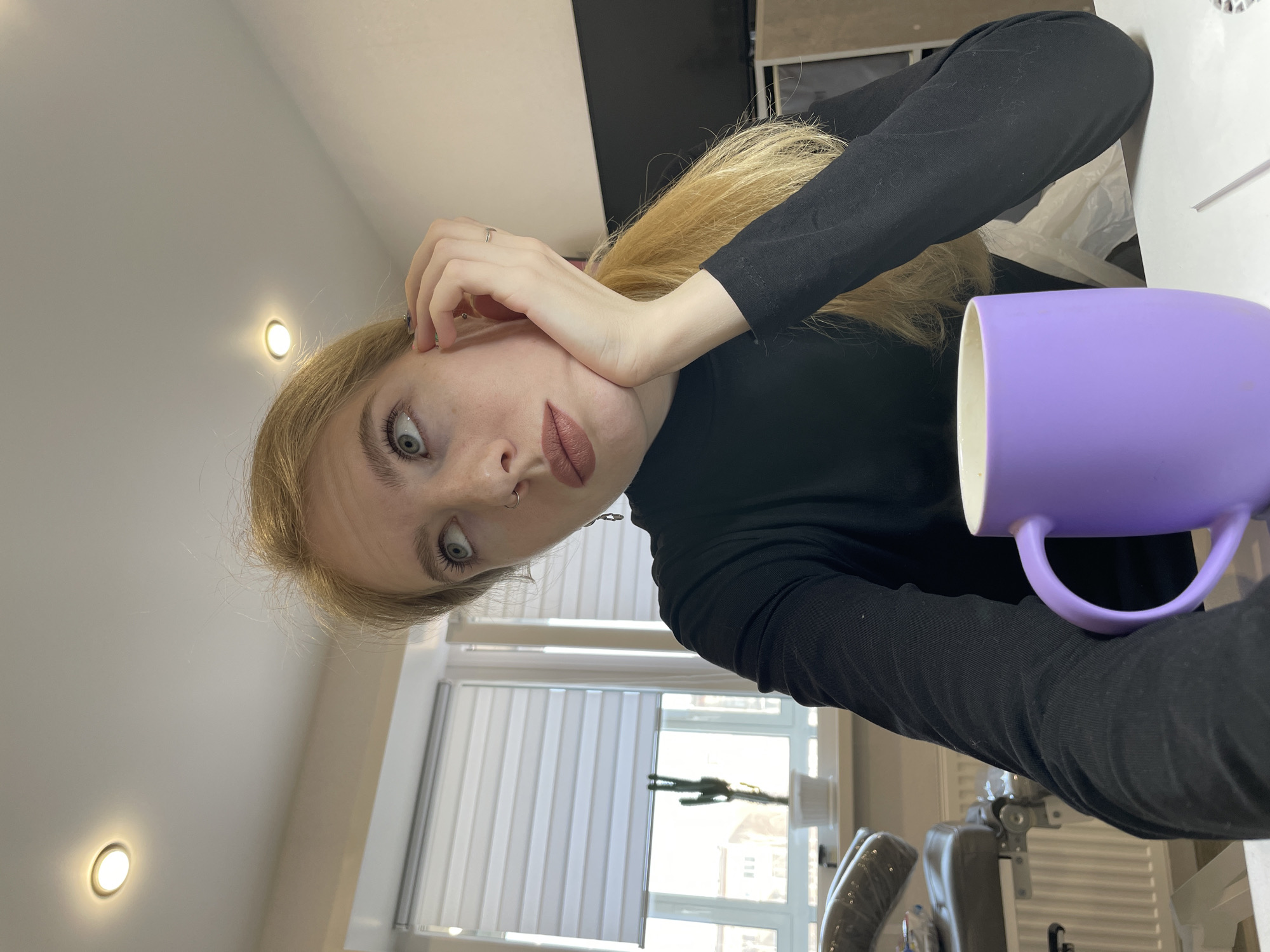 Woman poses for photos with purple mug in Izhevsk