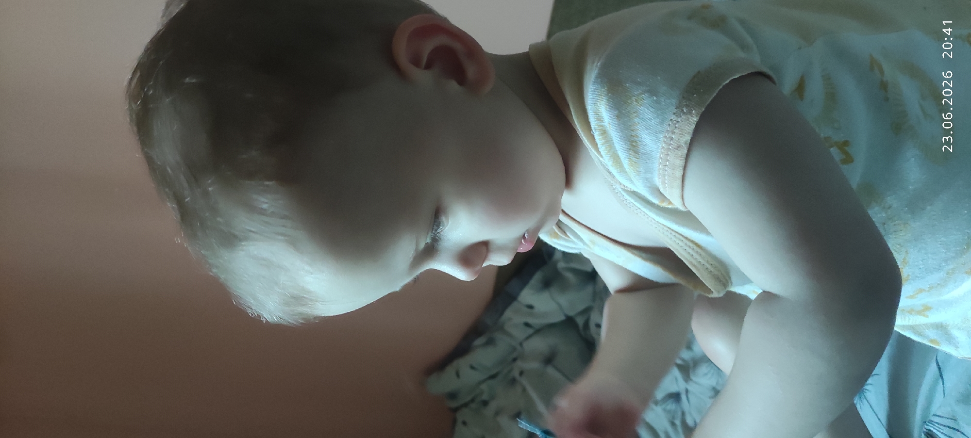 Quiet close-ups of a sleeping child on a patterned sheet.