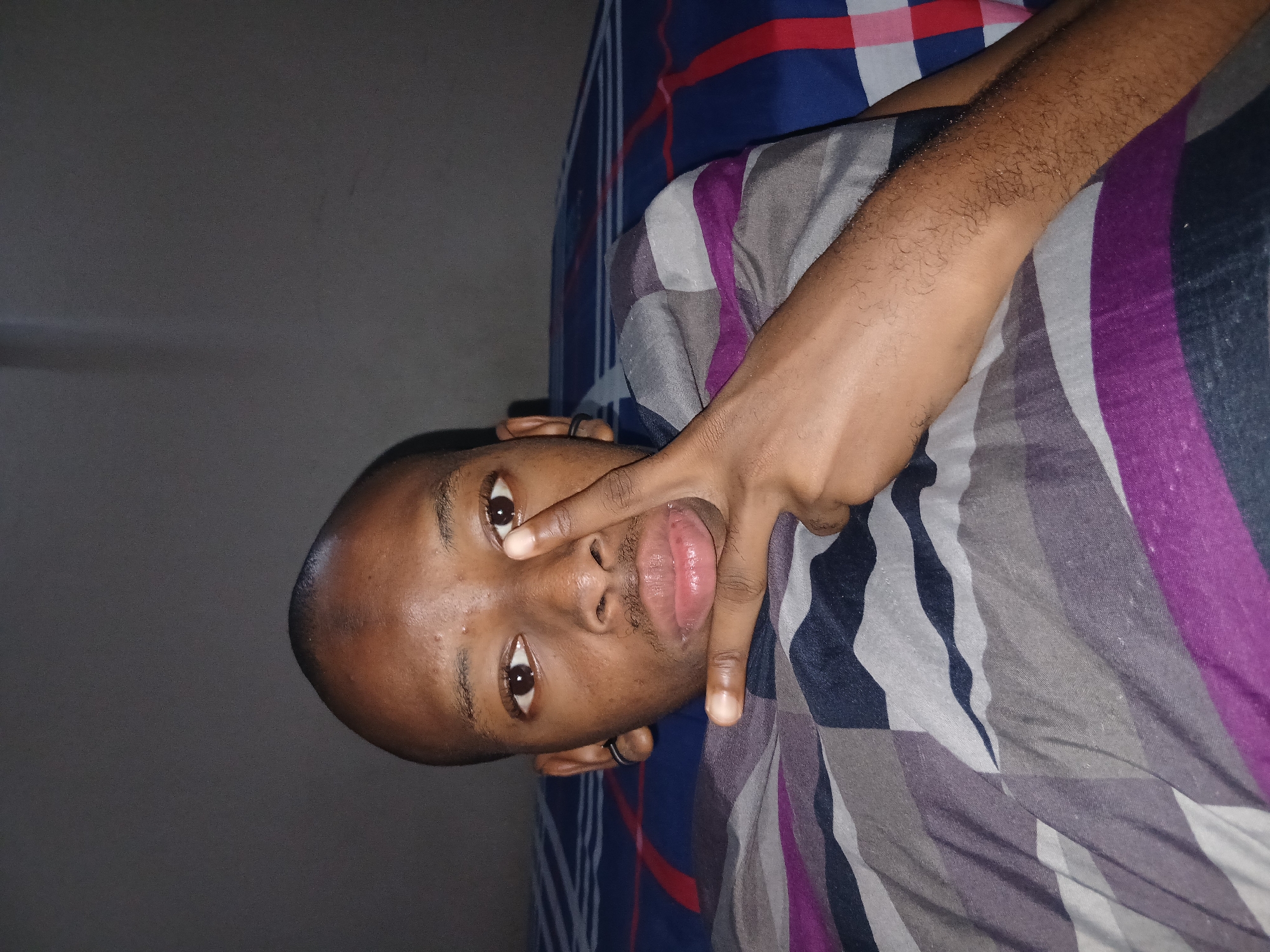 Peace sign selfies from a Lagos bedroom, late July night.