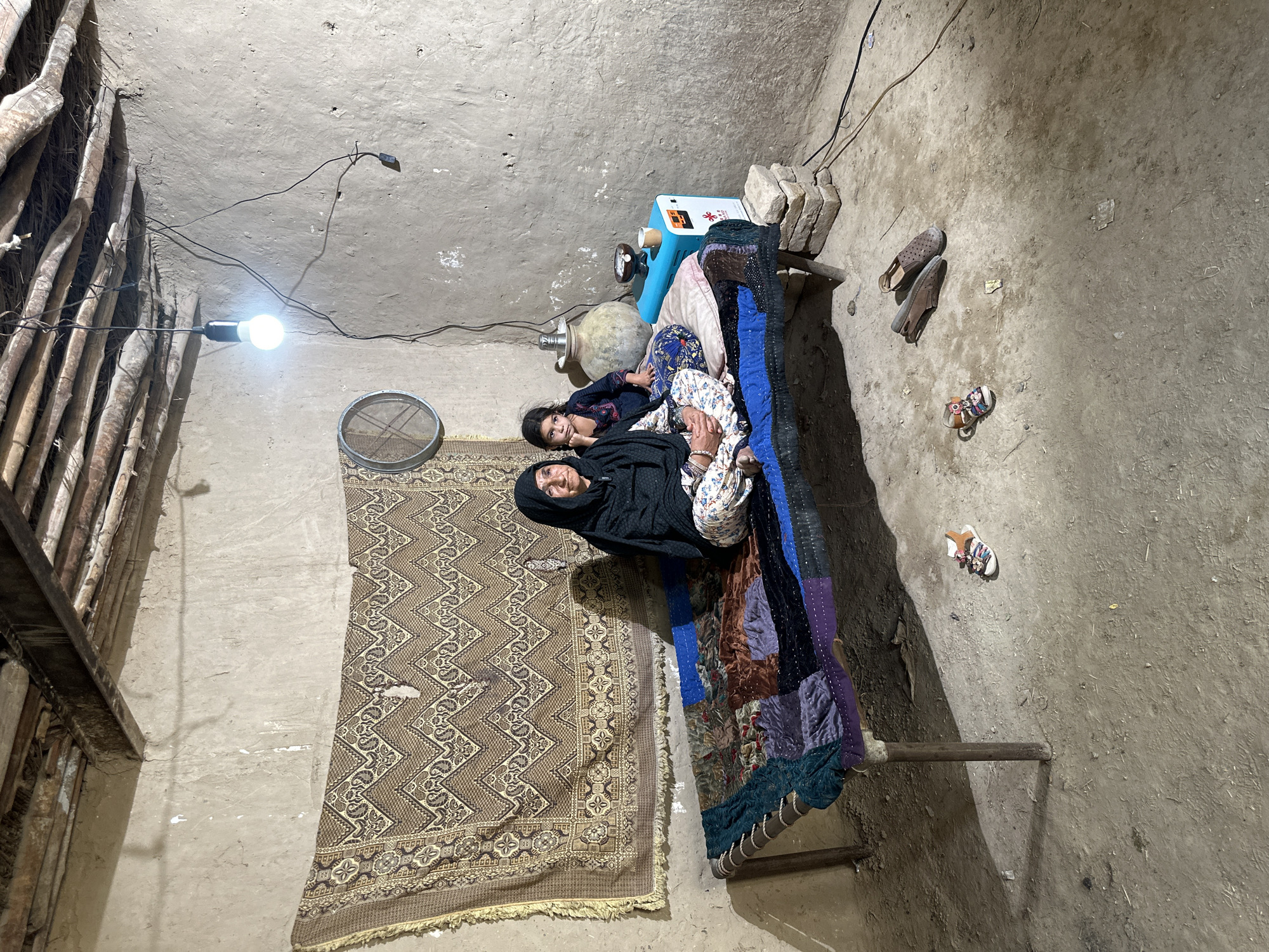 Elderly woman rests at home in Quetta dwelling