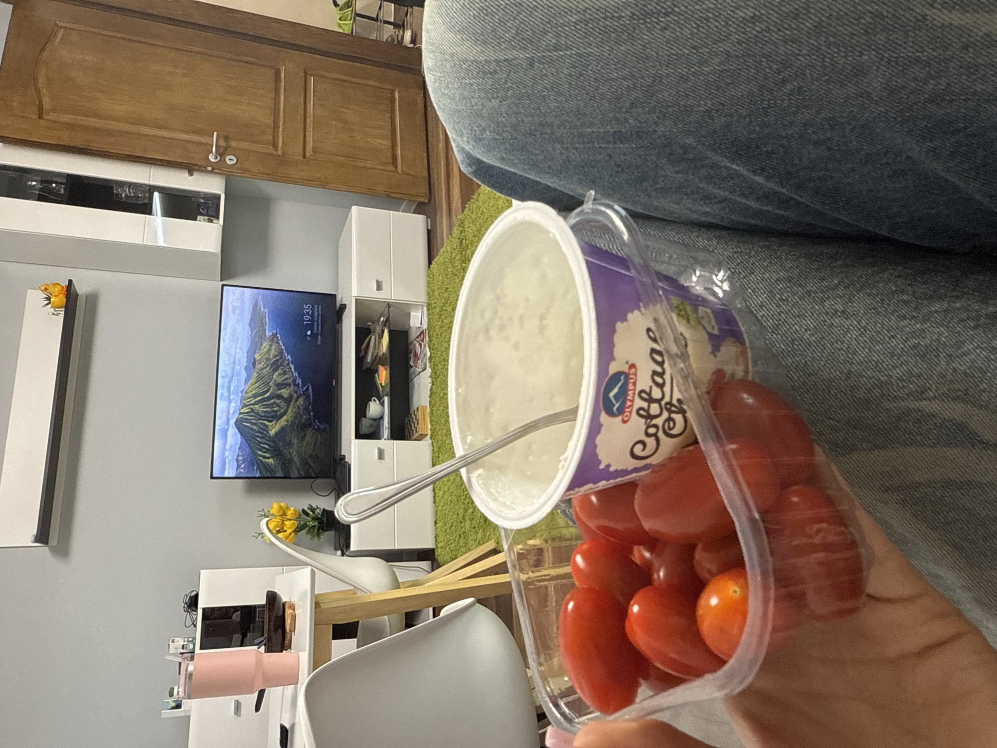 Person enjoys cottage cheese and tomatoes snack in Sofia