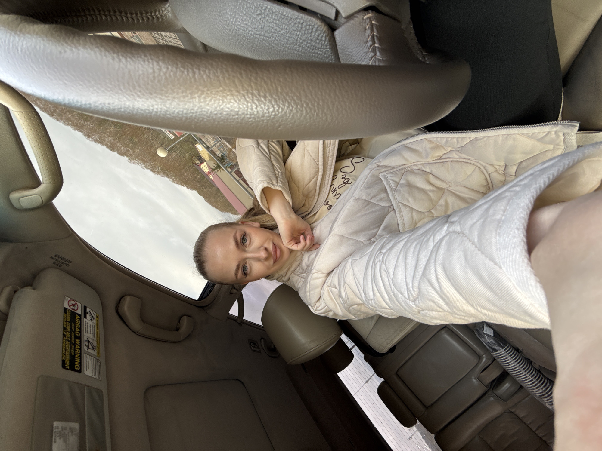 Woman takes selfies in car during evening in Petropavlovsk-Kamchatsky